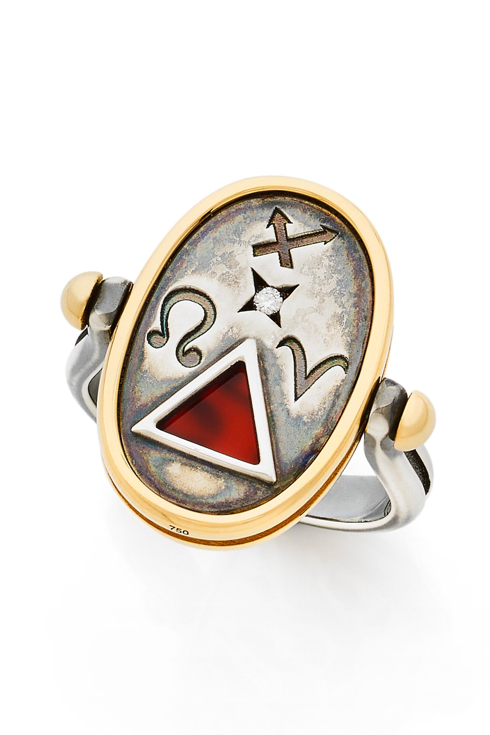 Gold and distressed silver ring. On one side, encrusted with a diamond, are engraved Fire signs (Sagittarius, Leo, Aries). On the other side is an openwork depicting a salamander on a carnelian base. 

Details:
Carnelian 
Diamond: 0.015 cts 
18k
