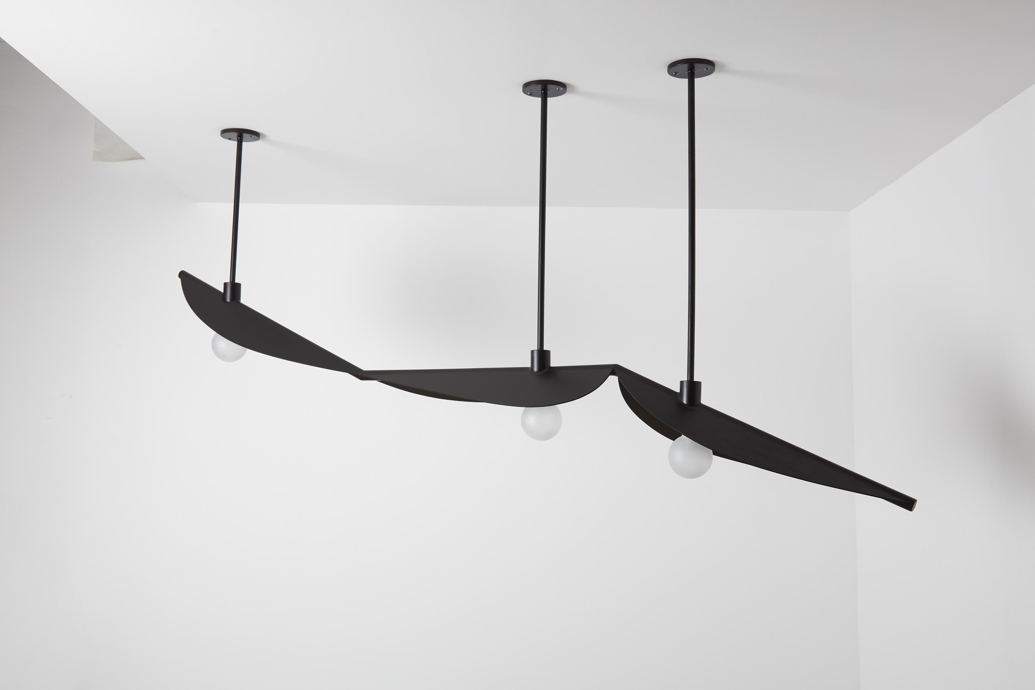 Feuillage trio ceiling mounted Black - Carla Baz
Dimensions: L 220 x W 30 x H 85 cm
Weight: 15 kg
Material: Black steel

Feuillage is a lighting installation composed of fine metal leaves delicately welded on a branch holding frosted glass