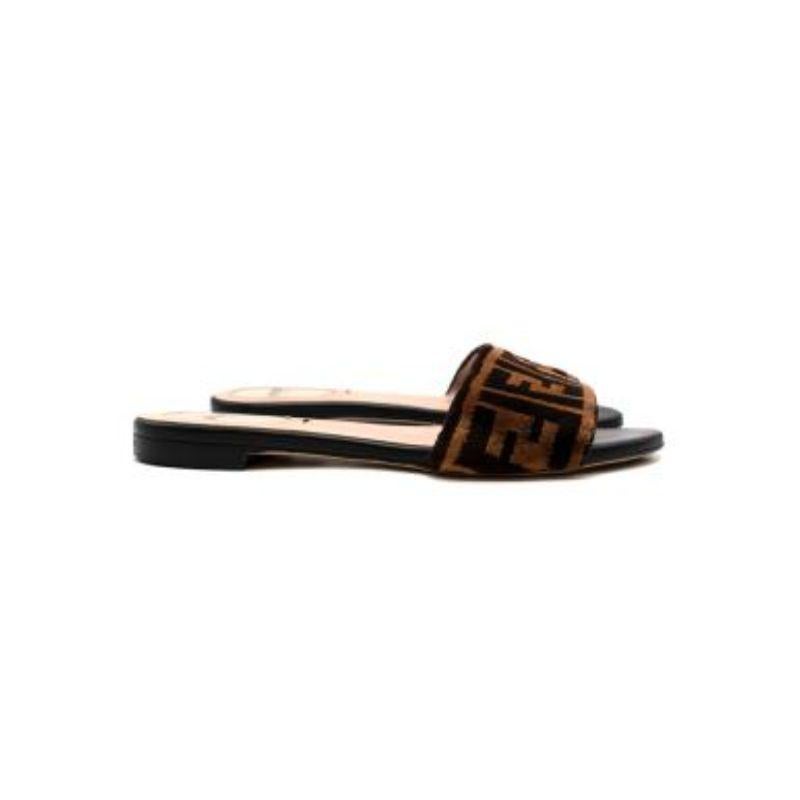 Fendi FF Black Jacquard Velvet Slides
 

 - FF monogram pattern strap 
 - Printed Fendi heel logo 
 - Fully lined with nude leather 
 - Open toe 
 - Slip on 
 

 Materials:
 Leather 
 Velvet 
 

 Made in Italy 
 

 9.5/10 excellent condition with no