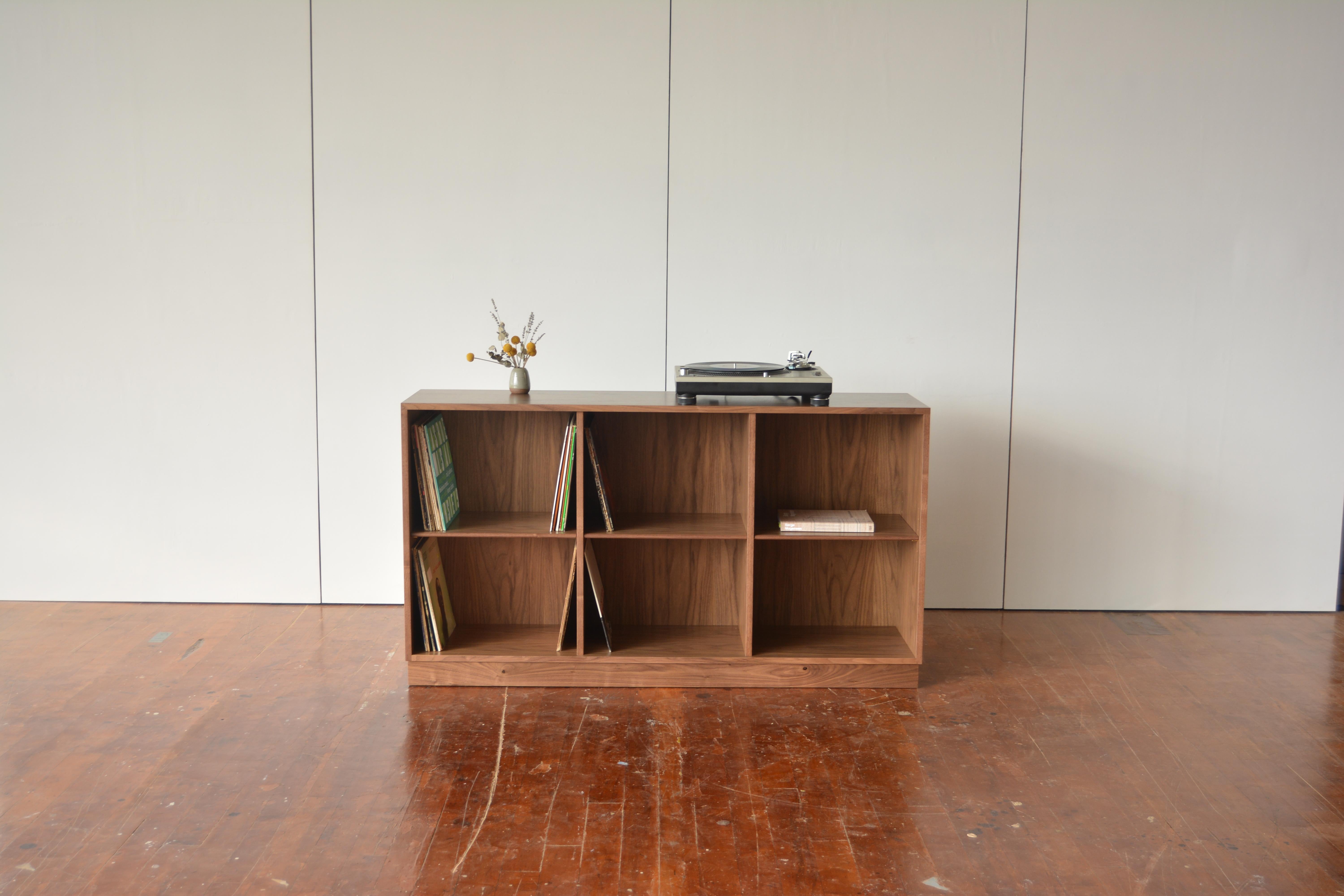 This low and deep bookshelf is sized for the storage and display of records or art books. An interior depth of 14.5