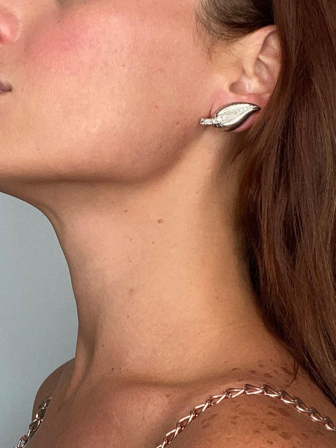 This is an exceptional pair of organics clips-on earrings, created in Paris France during the late art deco period, back in the 1940. The gorgeous pair has been designed as a left and right in the shape of leaves, which are embellished with