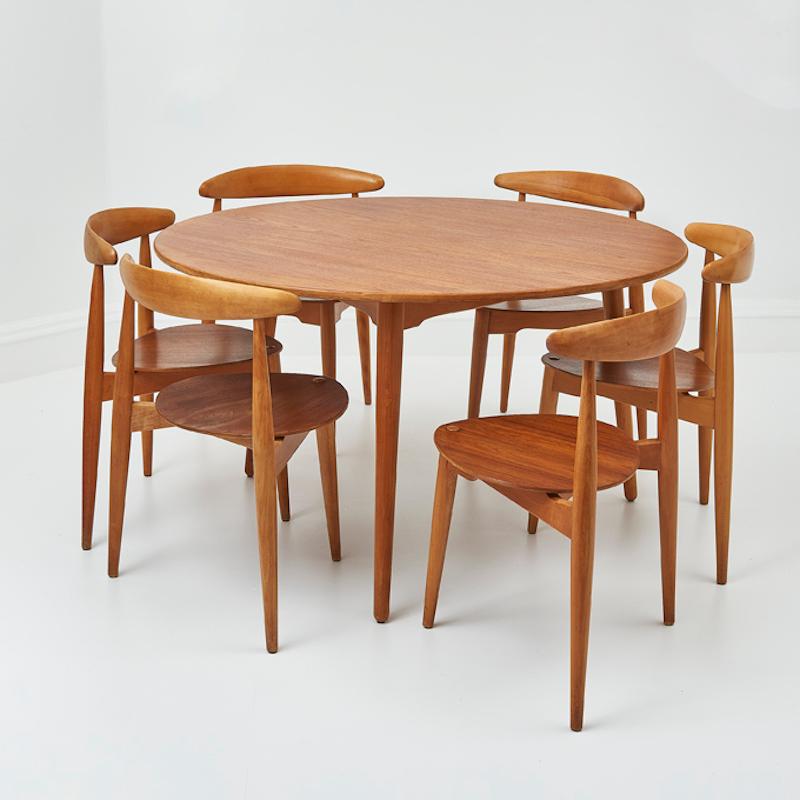 A rare and timeless dining set designed by the legendary Hans J. Wegner and Produced by Fritz Hansen circa 1950s. Known for his masterful craftsmanship and pioneering designs, this set embodies the essence of Scandinavian elegance and