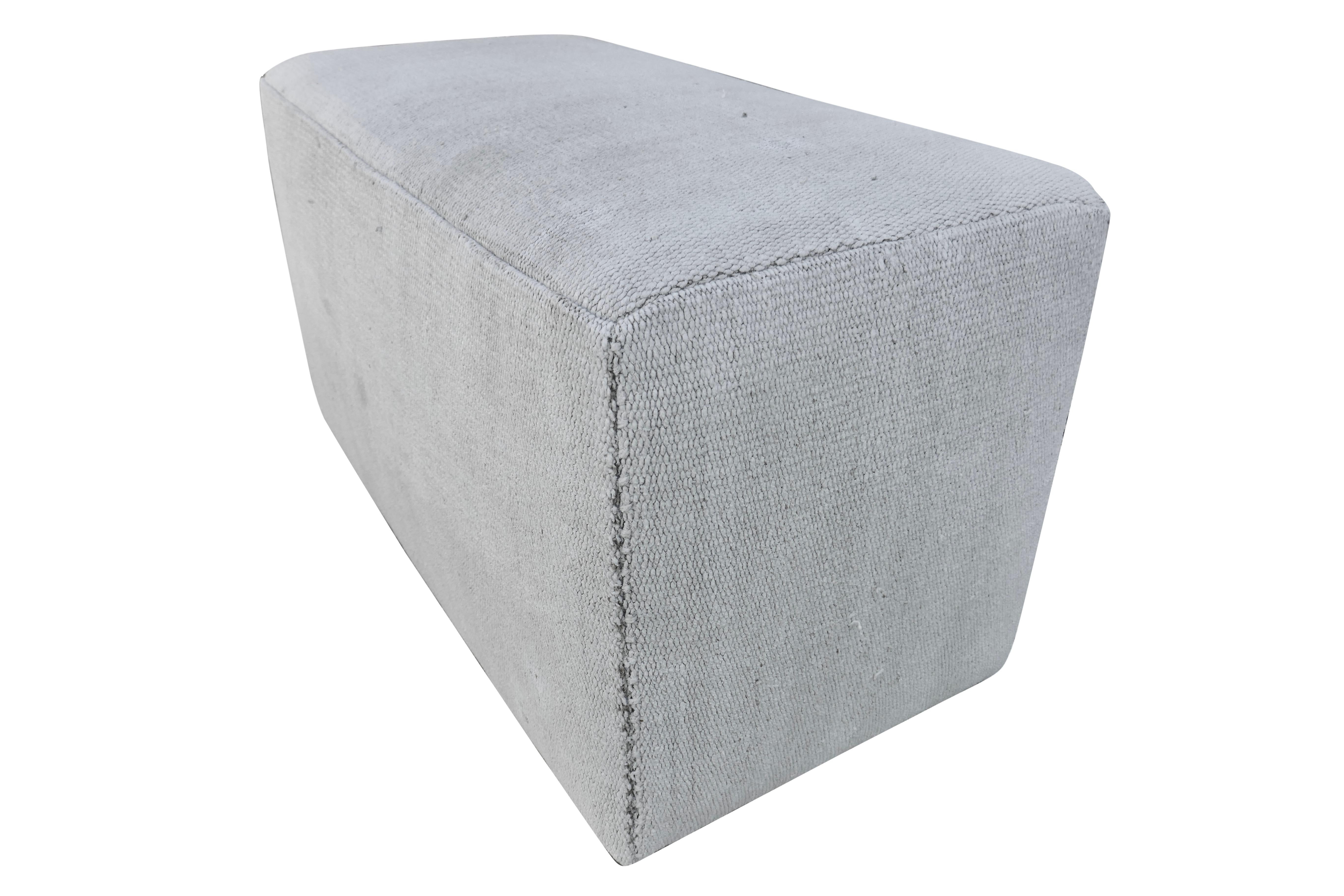 Custom versatile block ottoman/bench impeccably upholstered in authentic vintage Berber tribal hand-loomed heavy woven organic wool/hemp Kilim in its natural neutral color tone. Fully cushioned with soft edges and corners over a wooden inner-frame.