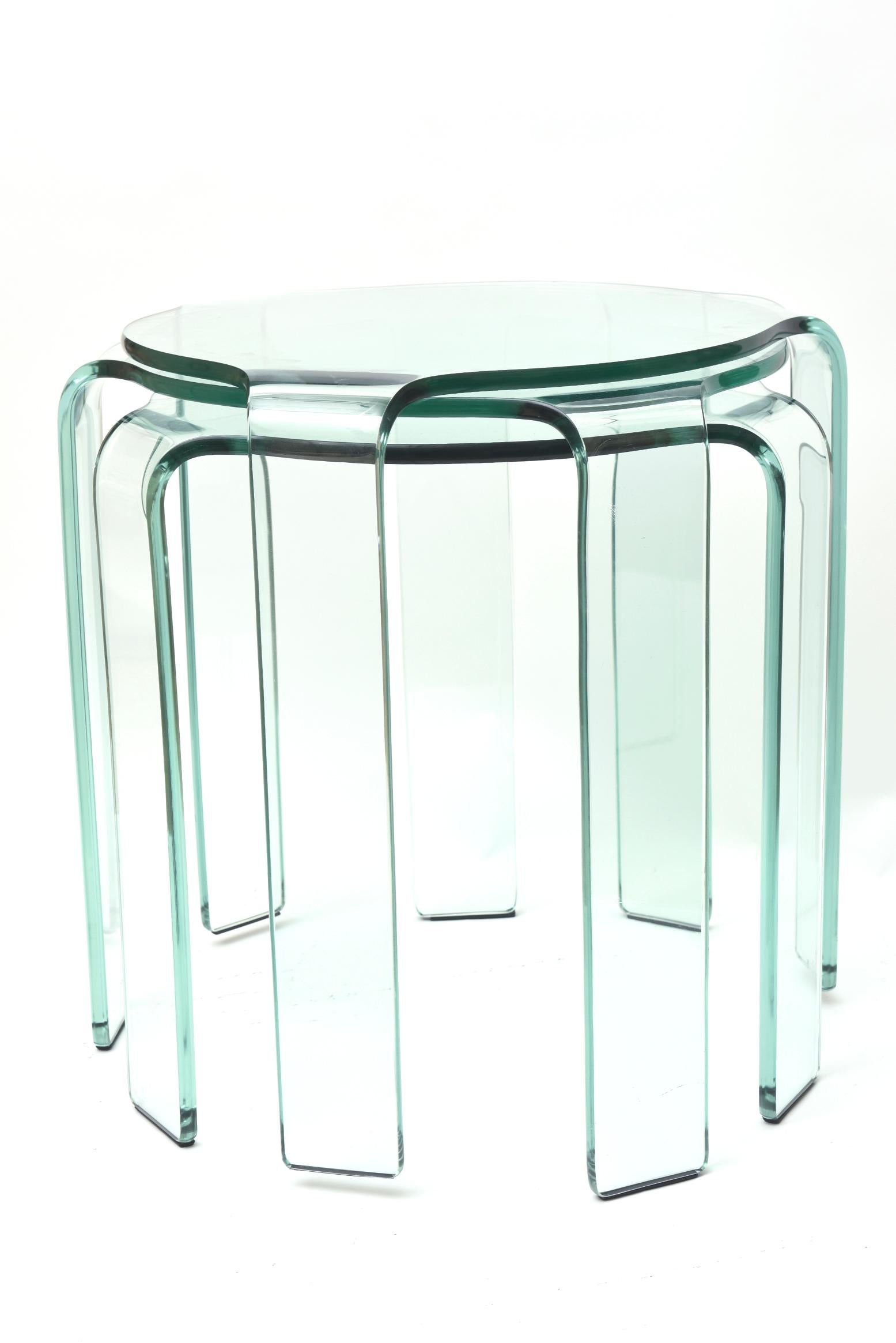 This set of Italian signed Fiam nesting tables are a set of 3. They are Italian and from the 1980s. Each one rests in each other. The overall dimensions are
what is given below. They have a slight green tint to them. Each one graduates ever so