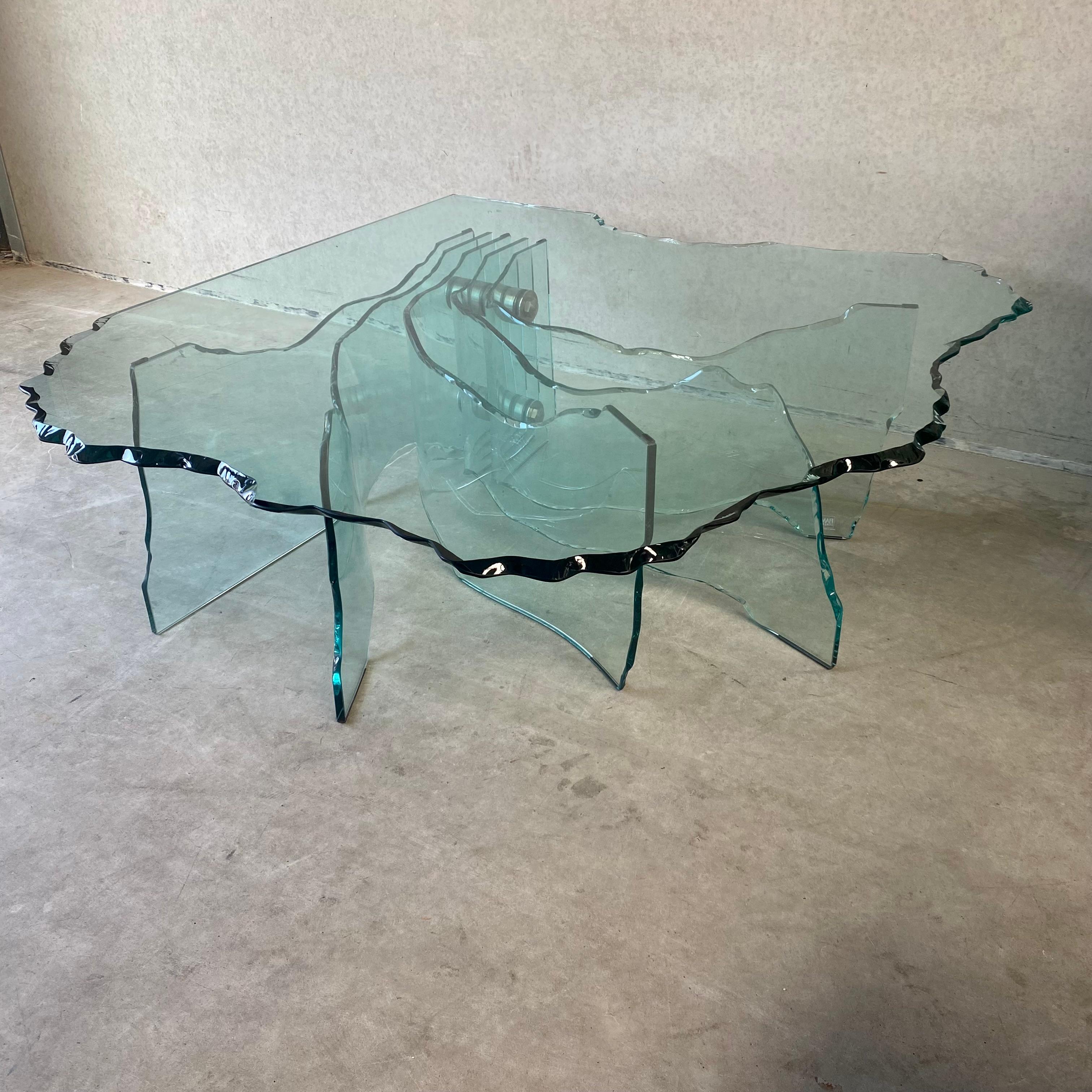 Introducing the breathtaking SHELL coffee table, a true masterpiece of design by the renowned artist Danny Lane for Fiam Italy. With its hand-sculpted elegance and exceptional condition, this stunning piece is sure to captivate any interior