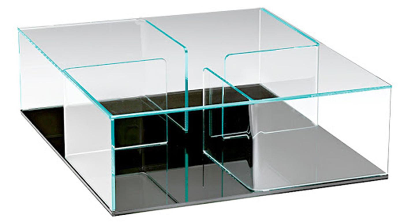 Coffee table/storage unit composed of 4 elements in 10 mm curved glass mounted between two 10 mm glass racks. Top and partitions in extralight glass, bases available in extralight glass, back-painted extralight glass, extralight mirrored glass,