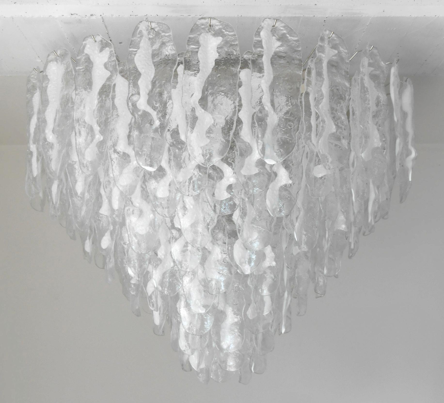 Italian chandelier shown with hand blown clear and milky white Murano glass leaves, mounted on chrome finish frame by Fabio Ltd / Made in Italy
21 lights / E26 or E27 type / max 60W each
Measures: diameter 45 inches / height 31.5 inches plus chain