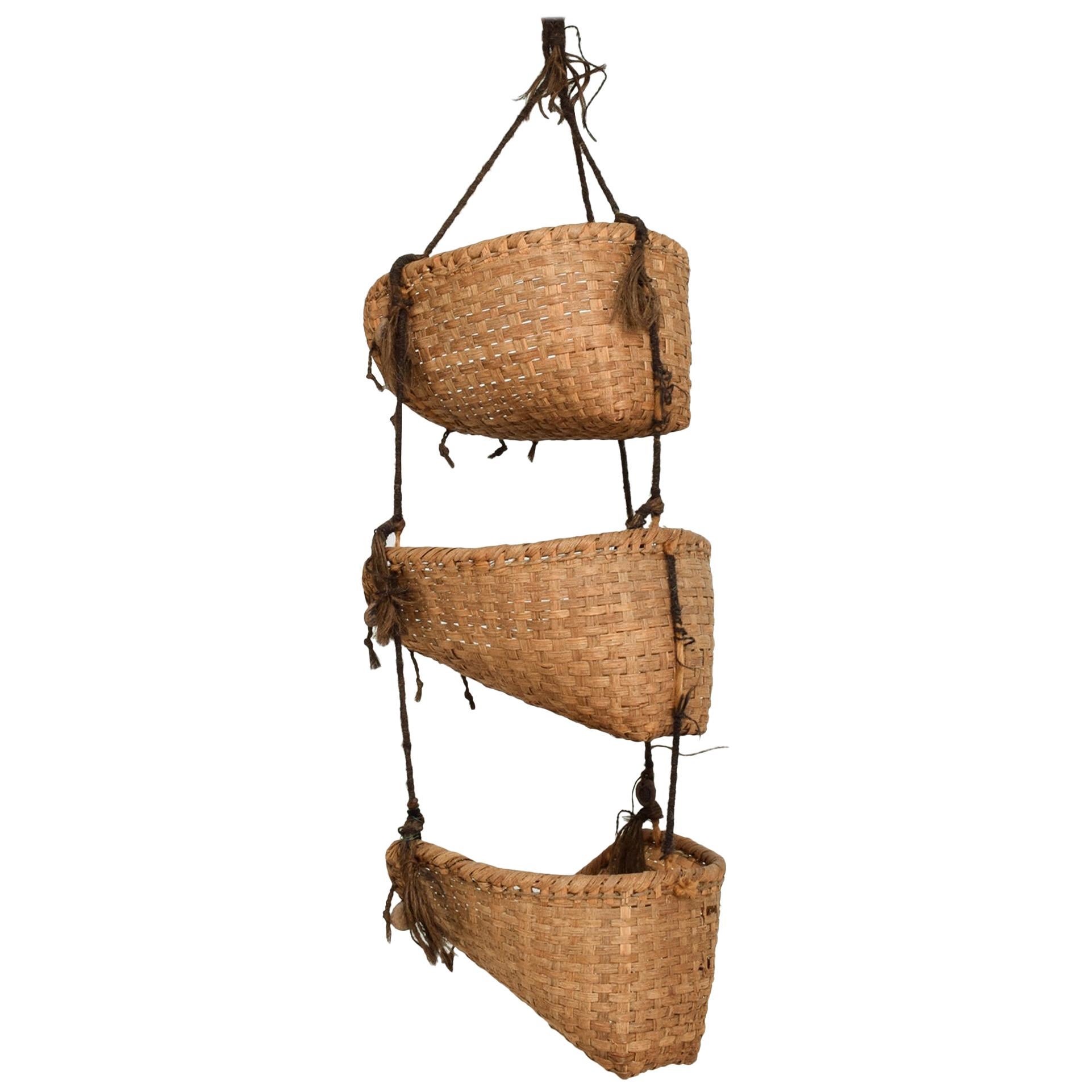 Folk Art
Handcrafted textile fiber art wall hanging with three storage nesting pockets
Hand woven basket pouches connected with a medley of fibers incorporating wool and animal hair each features a uniquely designed pottery medallion.
Wall
