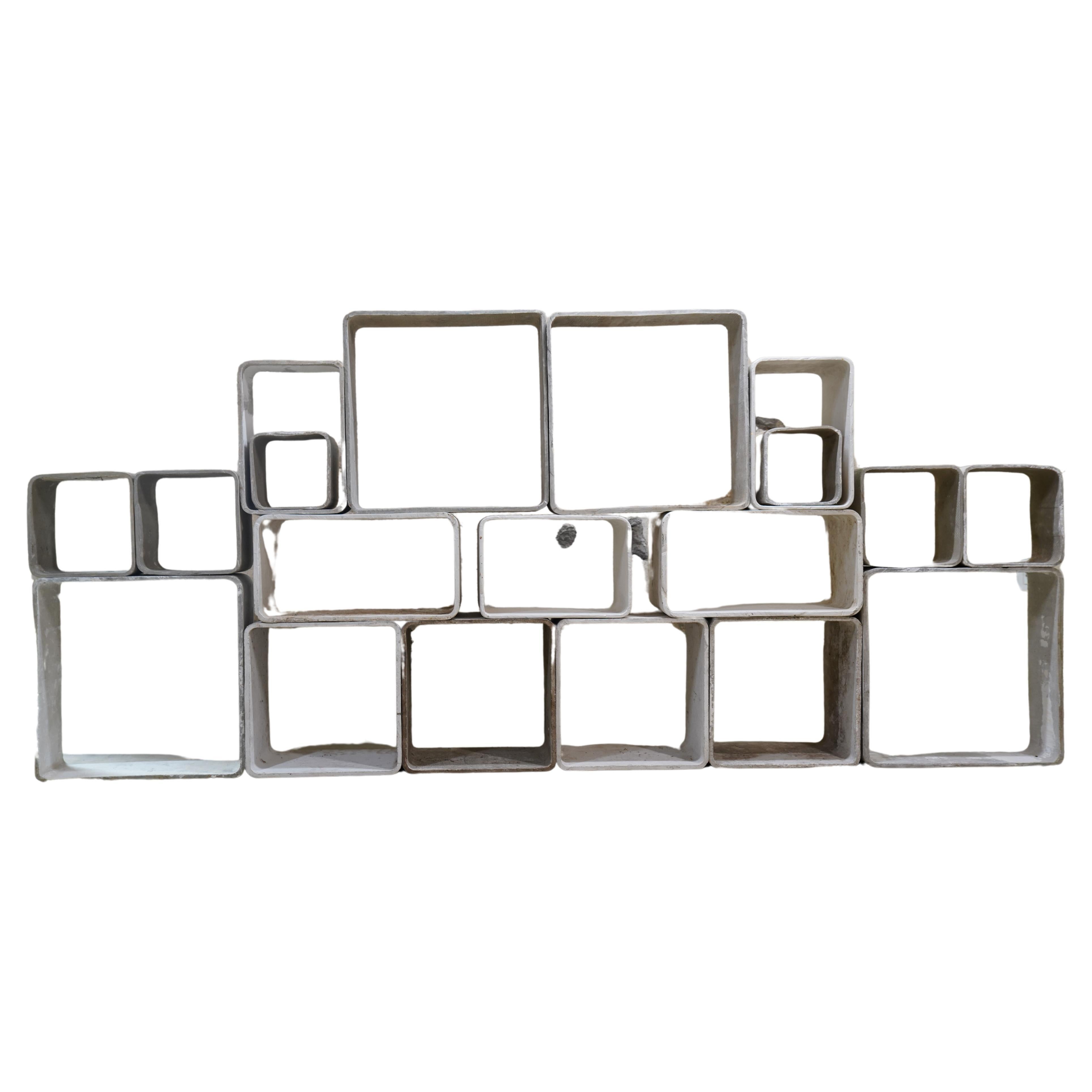 Incredible concrete modular bookcase by Swiss architect and Industrial design pioneer Willy Guhl for Eternit, Switzerland, 1970's. 19 individual concrete cubes can be arranged in variety of shapes to suit whatever space.

Varying degrees of patina,