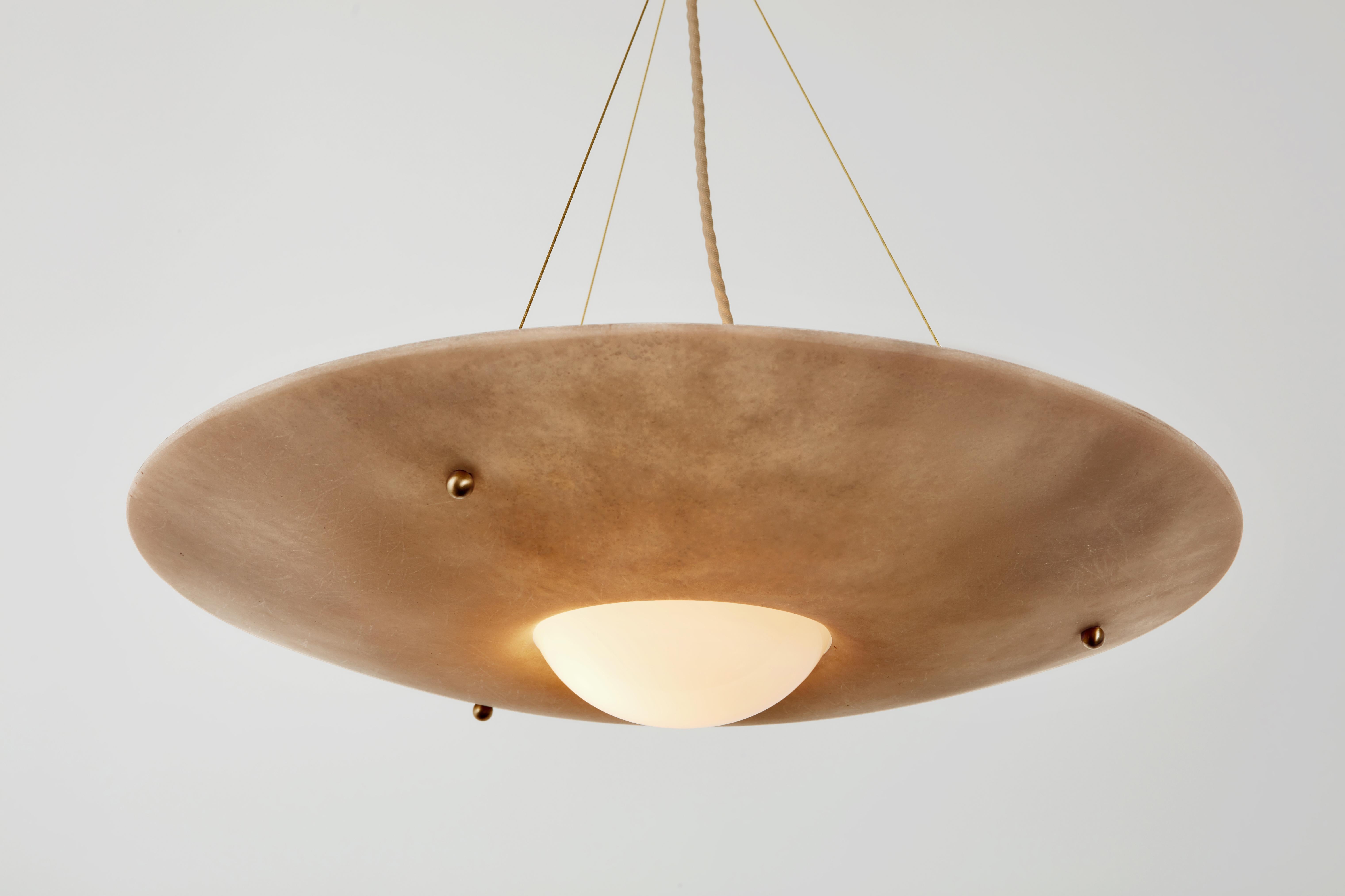 The Fiber series was inspired by nautical materials, textures and connections. The elemental construction uses raw fiberglass discs, illuminated by open blown glass orbs to create airy architectural forms. Each component simply rests in another,