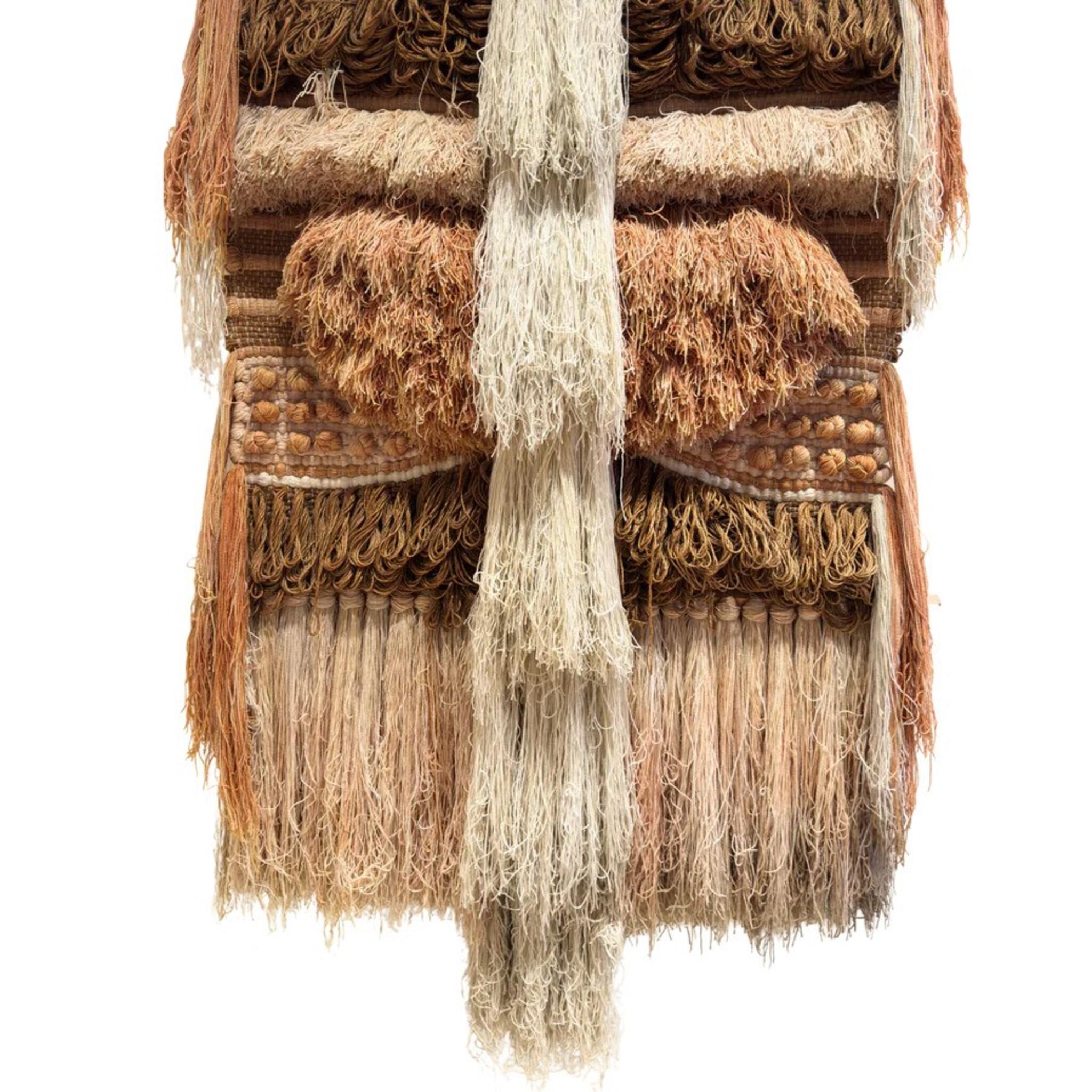 Large scale fiber wall sculpture by Margo Farrin O’Connor for Ted Morris & Associates, crafted in the 1970s. Composed of tonal bands of wool and jute in ivory, sand, rust, and ochre, the piece layers shag, fringe, coiled knots, and raised textures