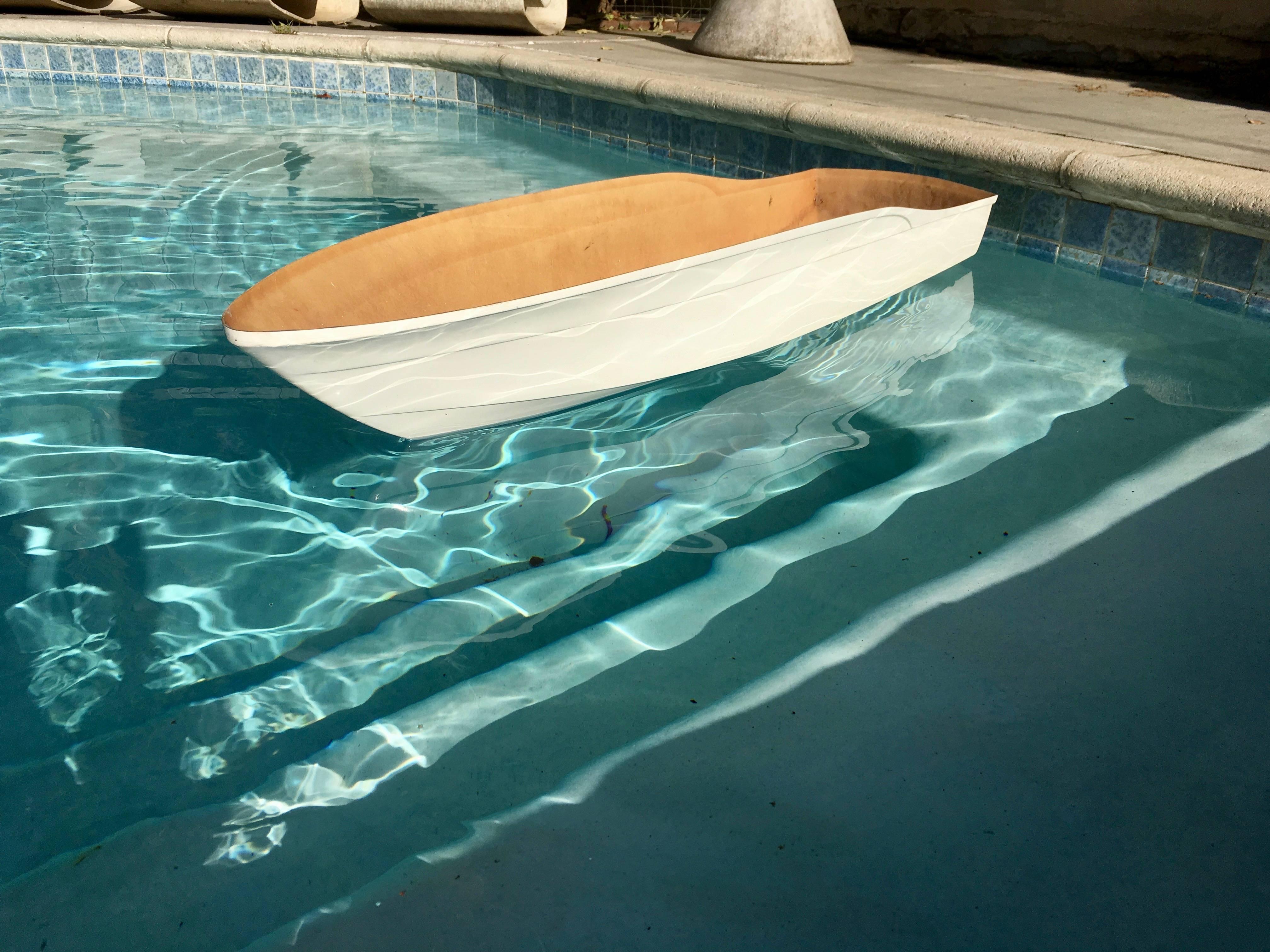 Large white fiberglass boat. Great sculptural object. Perfect art for the pool. Use in the pool to hold ice/drinks or as a floating planter. Very unique piece.