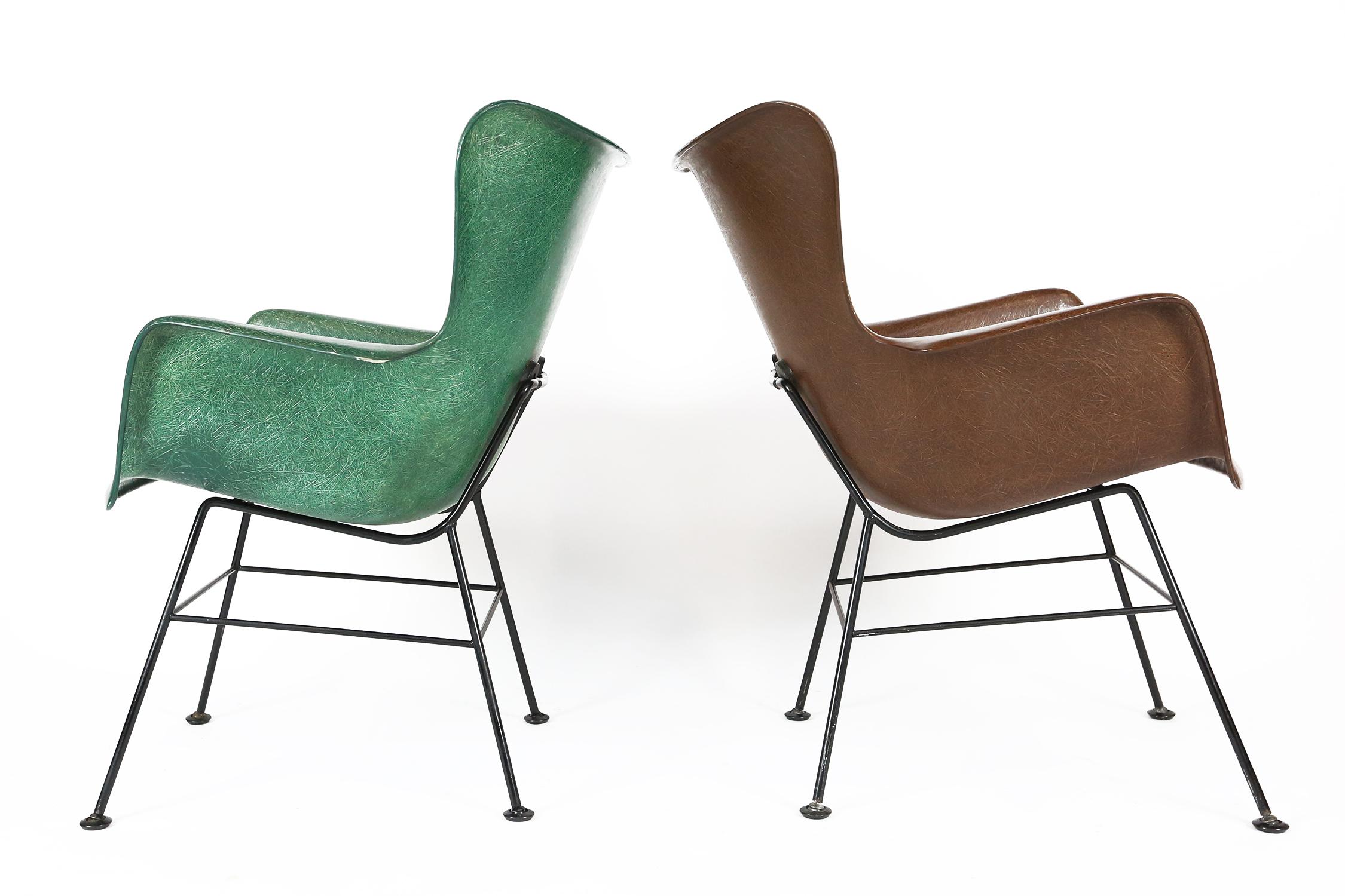 2 super comfortable fiberglass shell chairs designed by Lawrence Peabody in green & brown fiberglass with black cast iron back support and cast iron legs. 
A nice counter point to the ubiquitous Eames shell chair. 

Shock mounts are in excellent