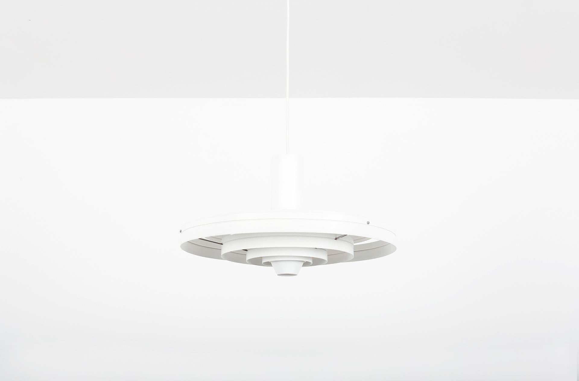 White lacquered aluminum. 
 
The Danish architect Sophus Frandsen designed this iconic pendant for Fog & Mørup in 1963. In the tradition of the Danish lighting pioneer Poul Henningsen, he did a lot of research to the nature of light. For most of