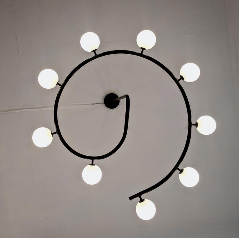 The FIBONACCI chandelier: Handmade to order by Blueprint Lighting NYC, this large round 9 globe brass chandelier is absolutely gorgeous and bridges the gap between modern and traditional design. 

The height and width can be customized to suit any