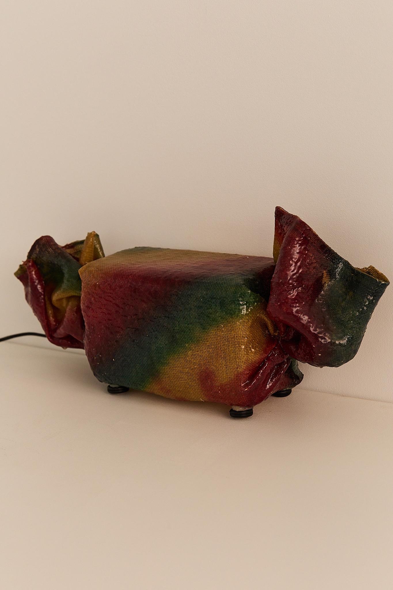 A rare and playful sculptural table lamp by French artist Lionel Scornec, designed circa 1975. Titled “Candy”, the piece takes the form of a wrapped sweet, crafted in richly colored, translucent resin and fiberglass.