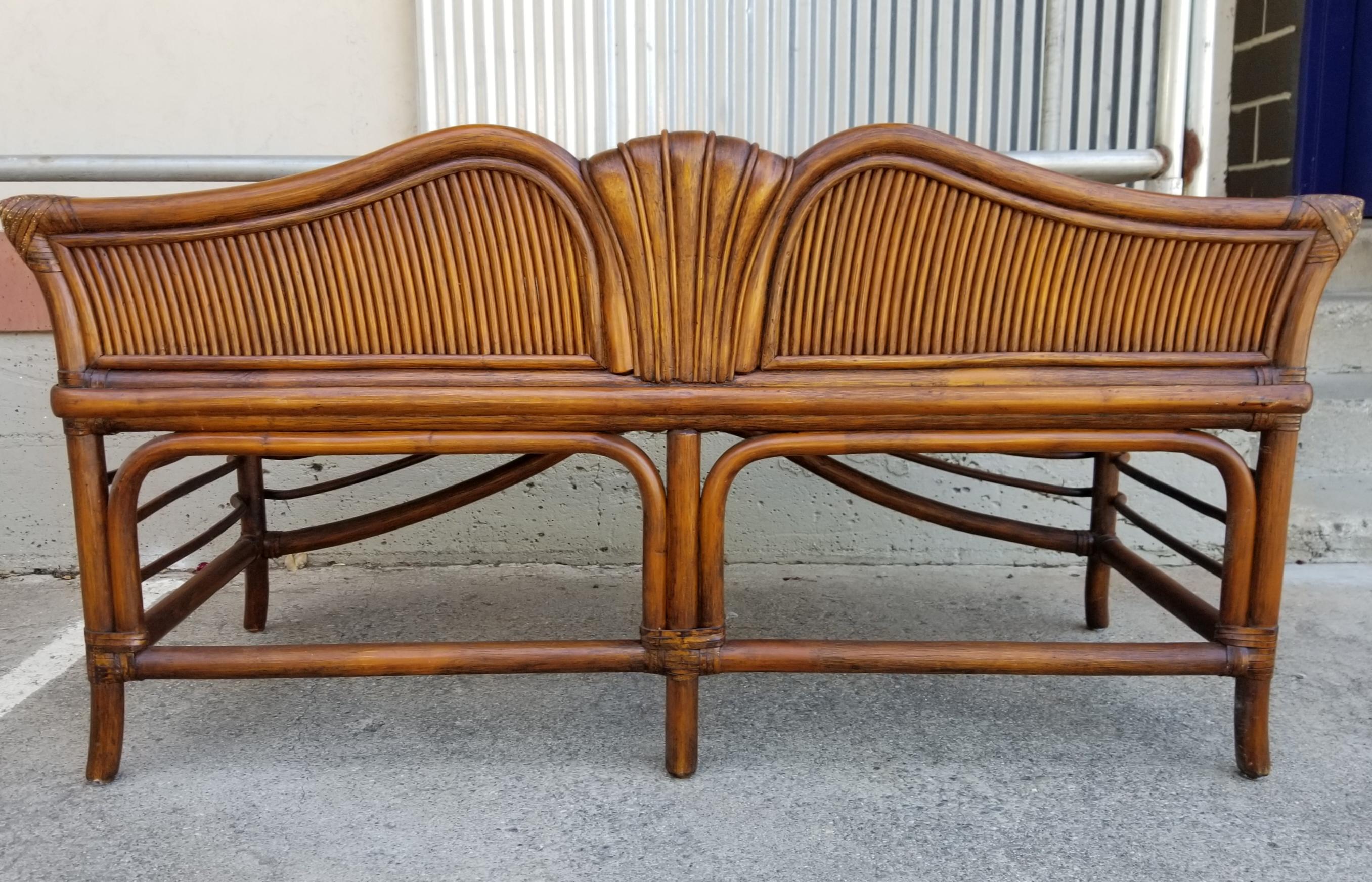 An unusual bamboo / rattan bench by Ficks Reed. Original finish and upholstery. Very good vintage condition. Structurally very sturdy.
