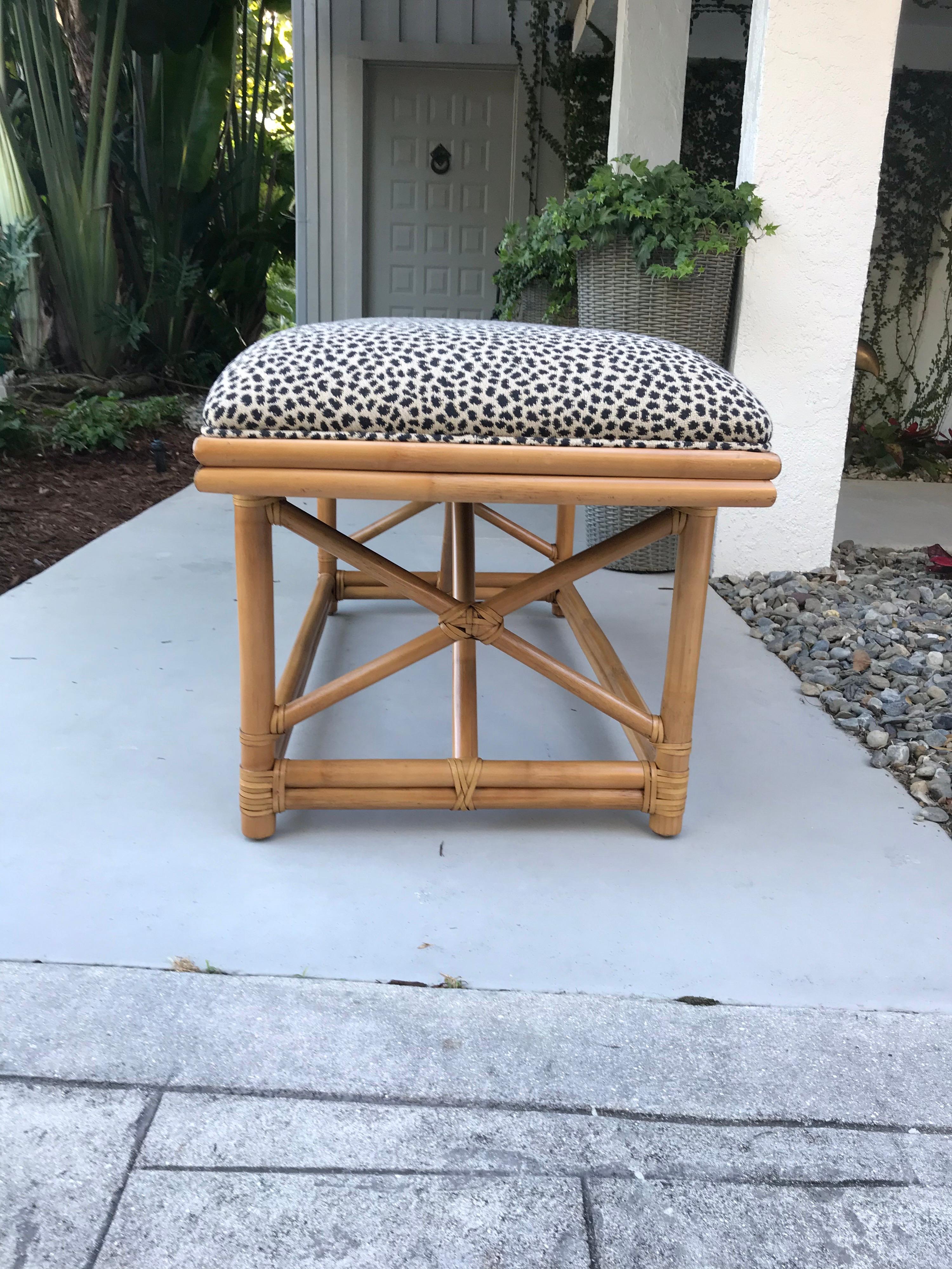 This is a Ficks Reed bamboo bench with animal print upholstery in great condition.