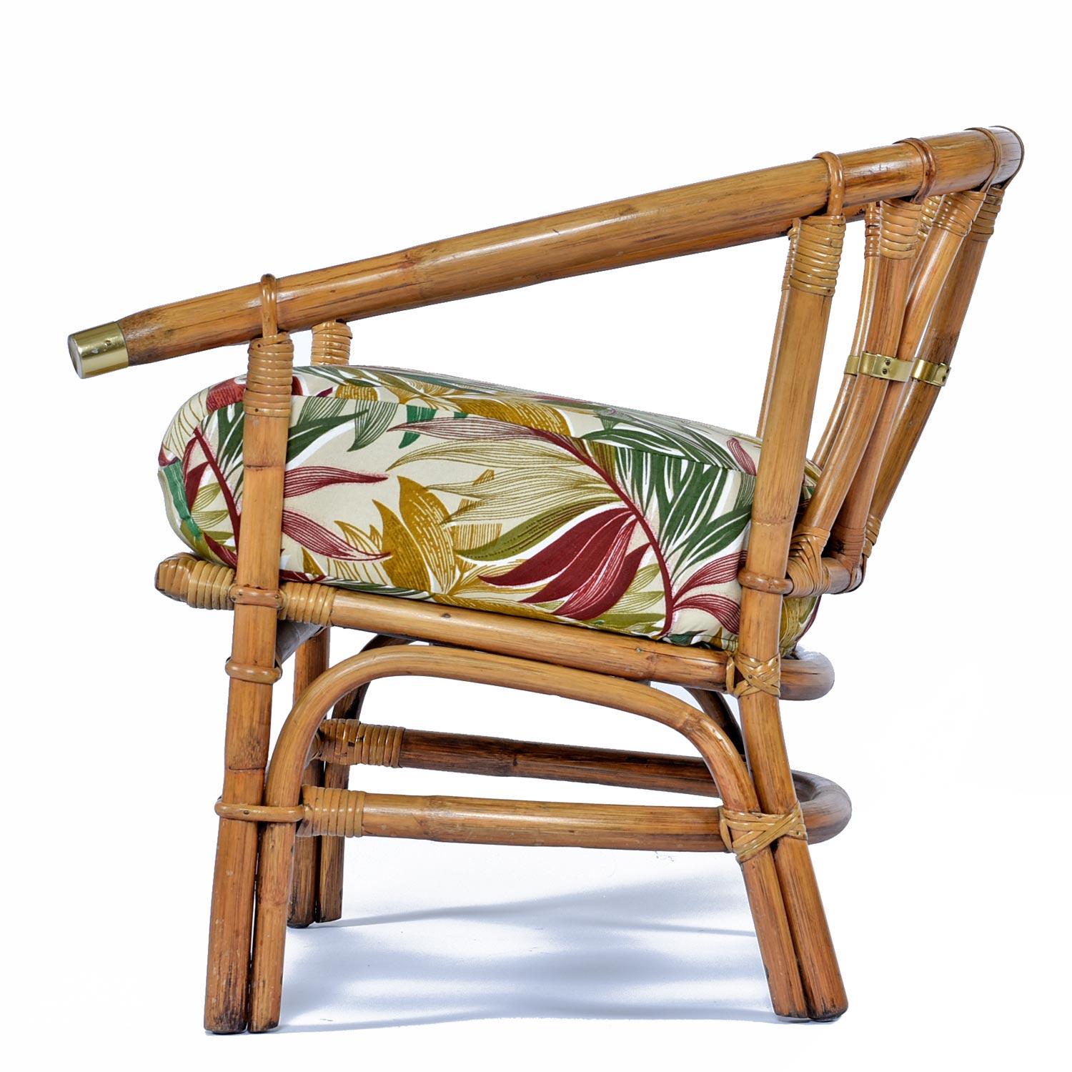 Inspired by the tropical lands of the the East, this bamboo armchair features stylish campaign style brass caps that punctuate the pagoda style arms. Intricately woven wheat colored bamboo twists and turns to comprise the scaffold of this chair. The
