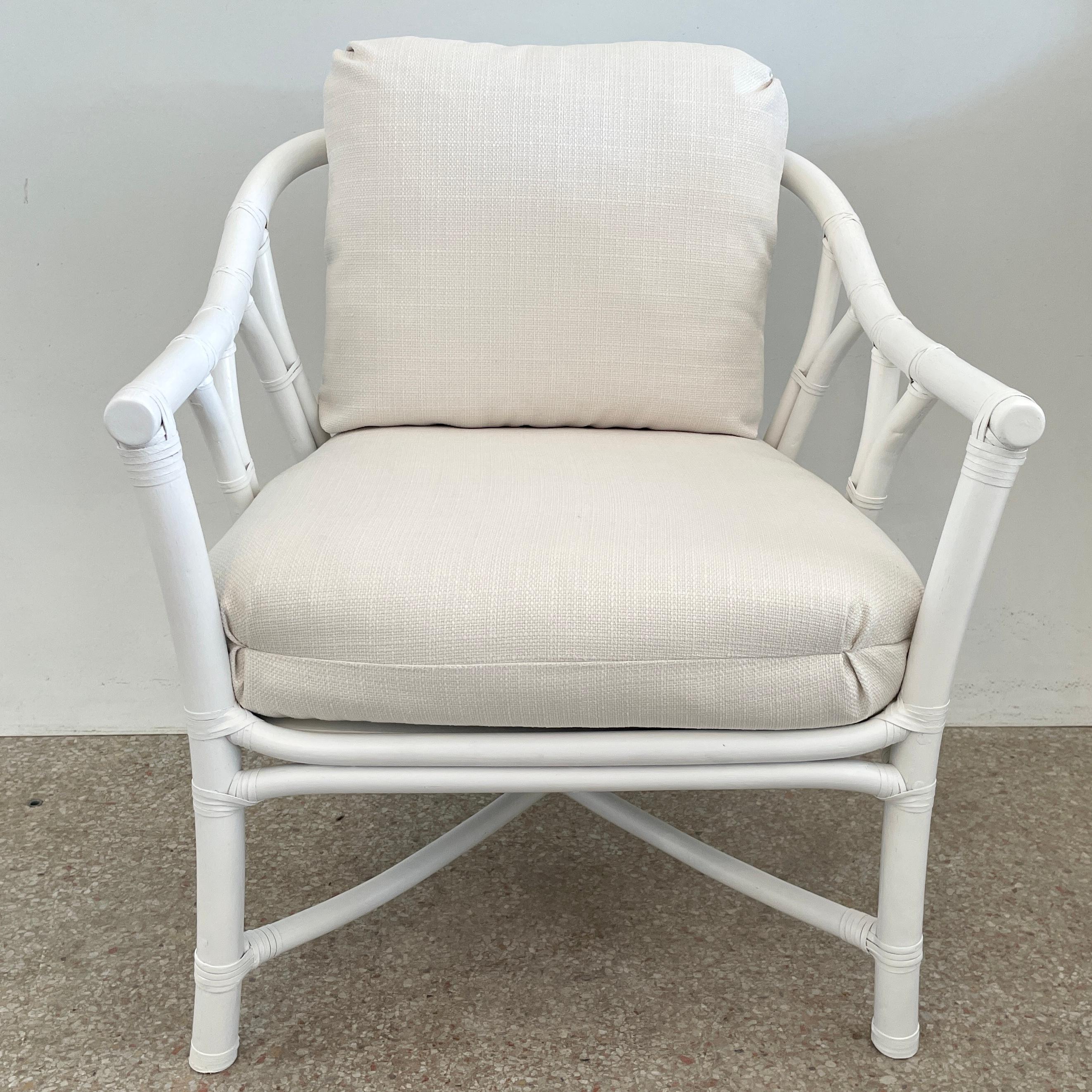 Fabulous Ficks Reed club chair upholstered in new Todd Hase High Performance cushions with frames newly lacquered in white. This piece has an authentic Ficks Reed label. Great addition to your boho chic interiors. We have three club chairs in stock.