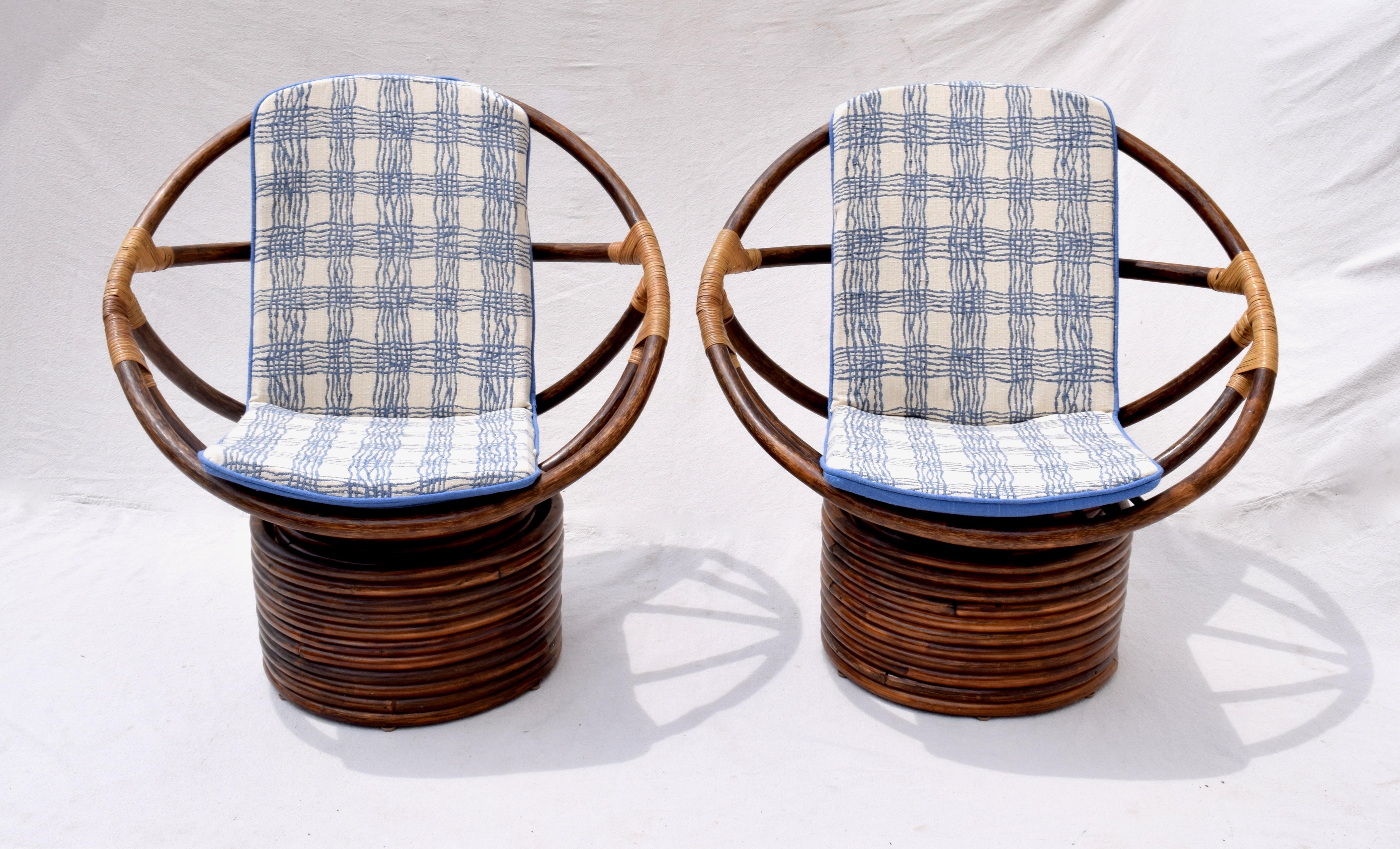 Large scale John Wisner Ficks Reed Far Horizons swivel bamboo rattan lounge chairs with new custom cushions upholstered in thickly woven Brunschwig & Fils cotton linen. Additional smaller scale matching chairs can be seen in our separate listing: