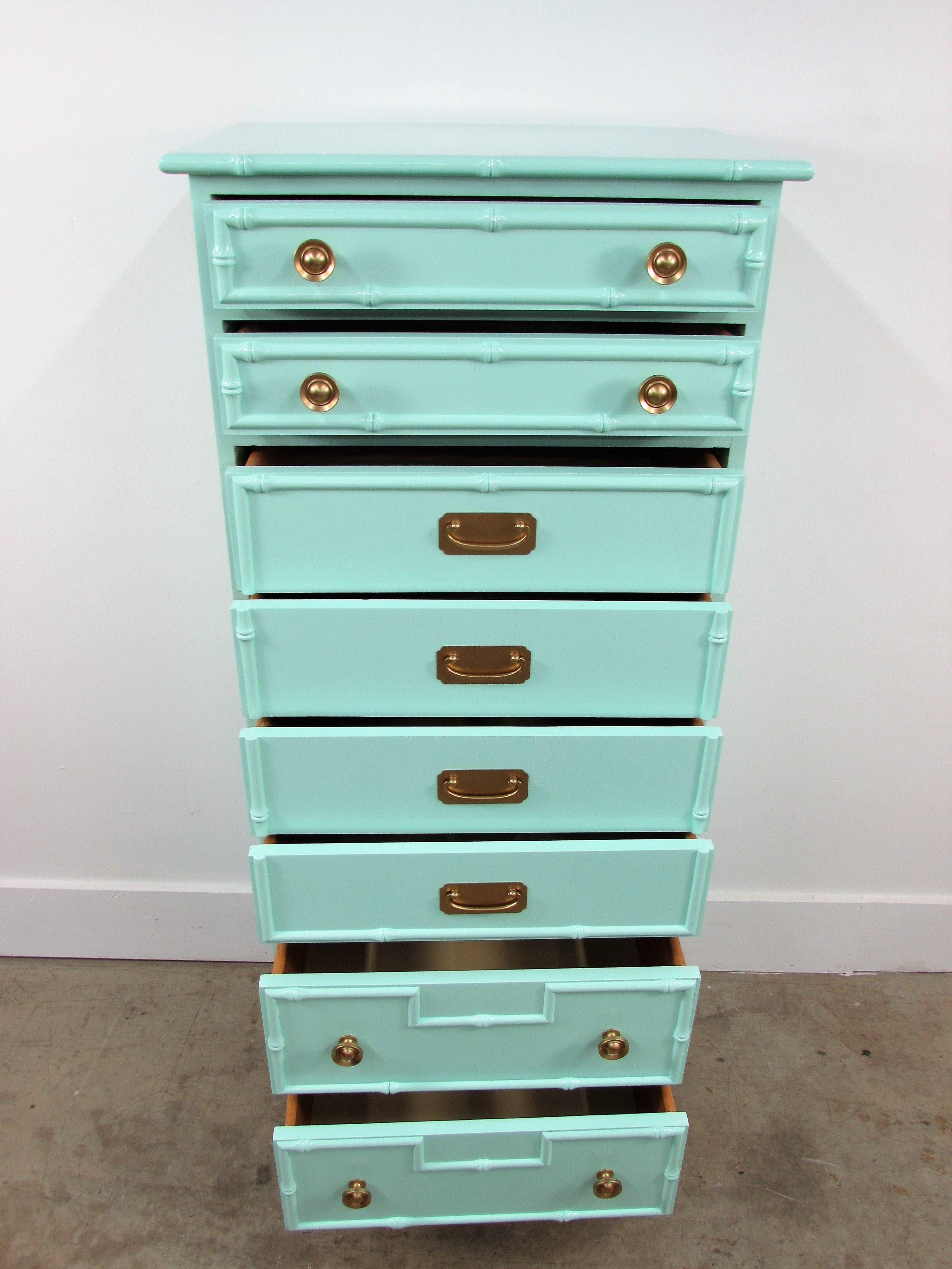 Ficks reed faux bamboo lingerie chest lacquered in Benjamin Moore 2039-60 Seafoam Green gloss finish and customized in-house with eight drawers suspended on four legs.