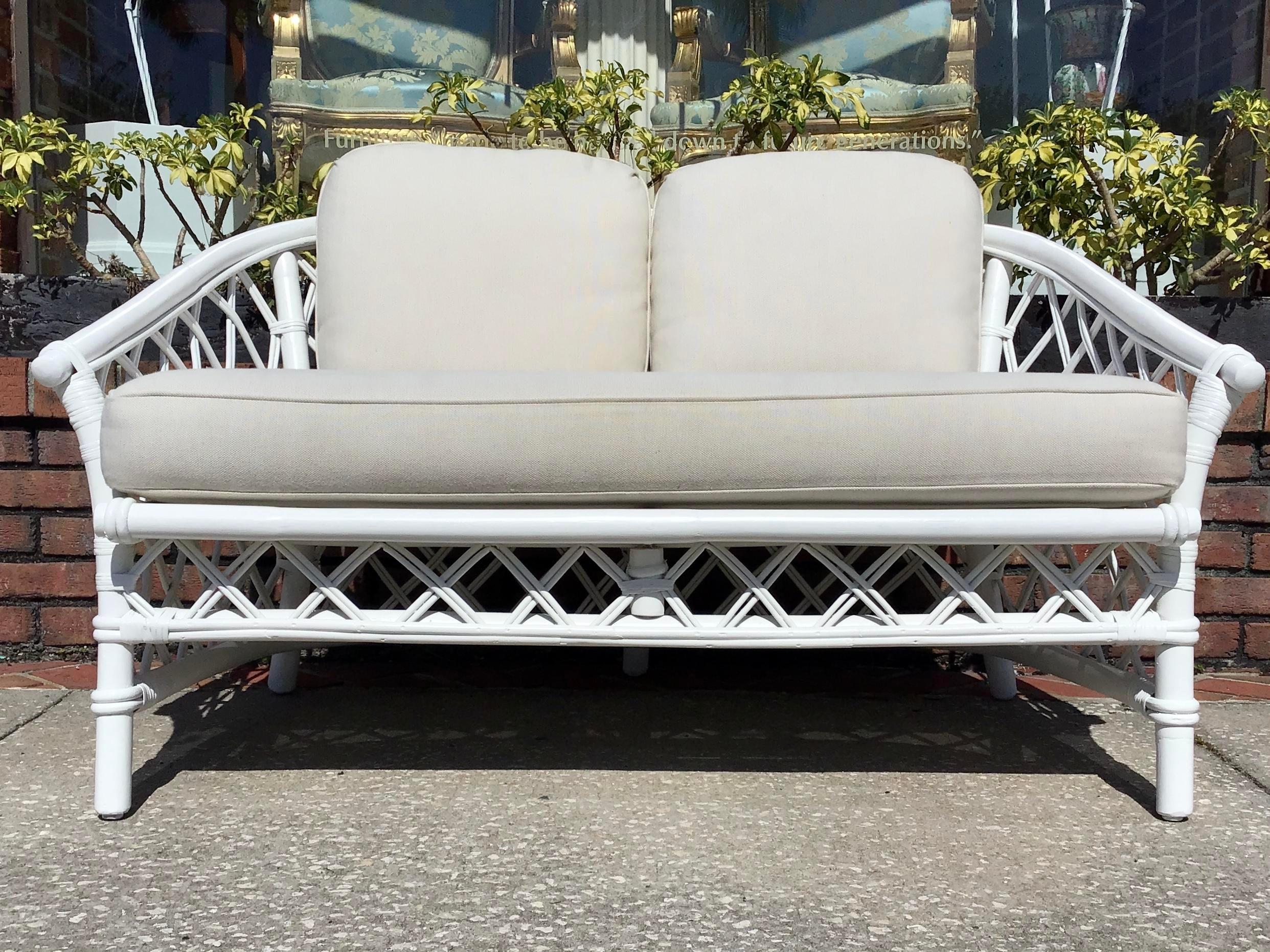 A small and cute Ficks Reed loveseat newly Lacquered in white and reupholstered with Todd Hase fabric cushions. Add this fun Boho Chic loveseat to your favorite room.