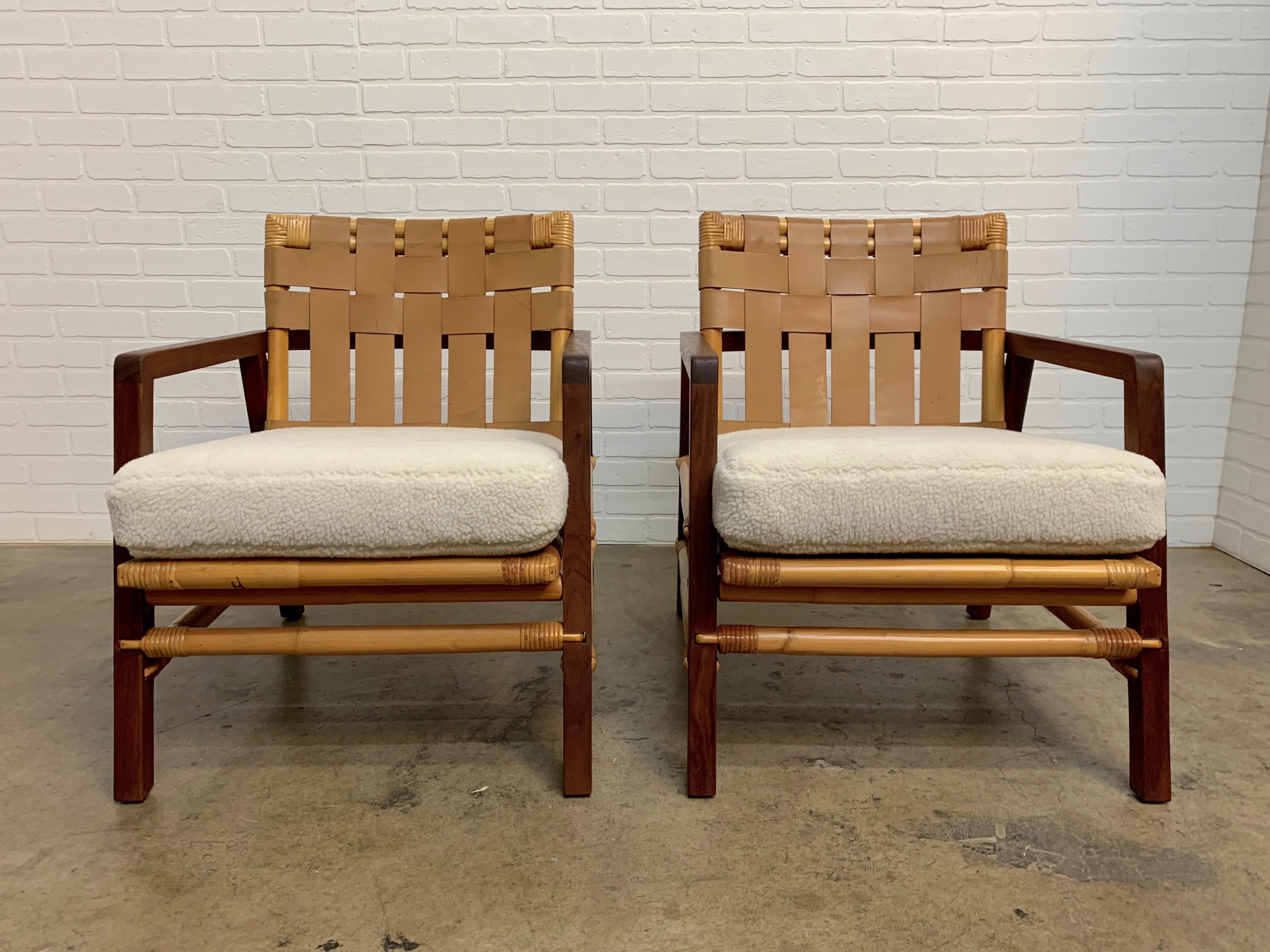 Pair of rare Ficks Reed midcentury Lounge chairs made with a combination of rattan, walnut, woven leather back and upholstered seat
The cushion has new Sherpa Faux fur.