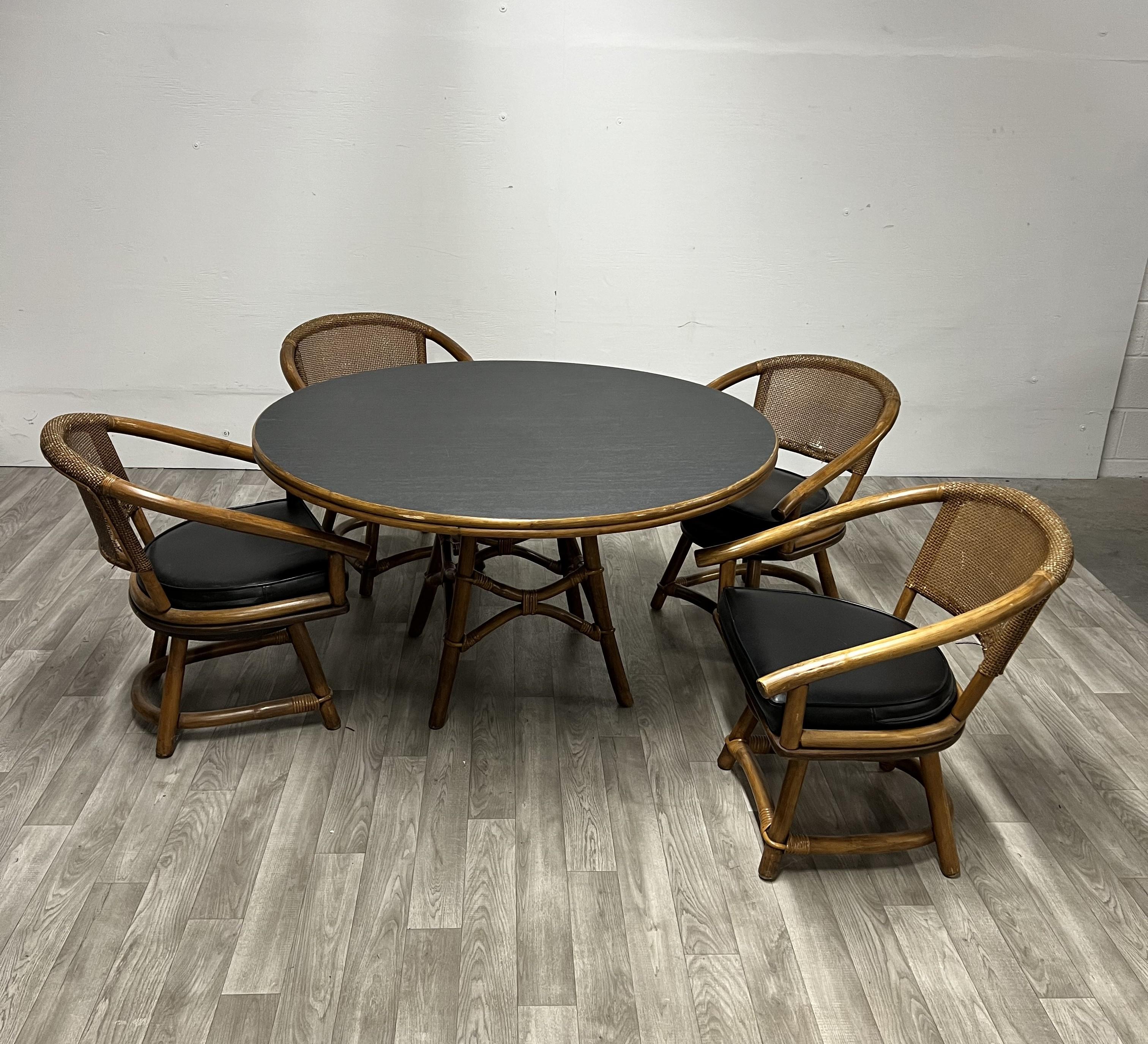 Rattan and Bamboo Dining Set by Ficks Reed

4 Barrell Back 180 Degree Swivel & Return Armchairs with Rattan Backs
Round Wood Table Top with Bamboo and Rattan Base

Table size height 47.5