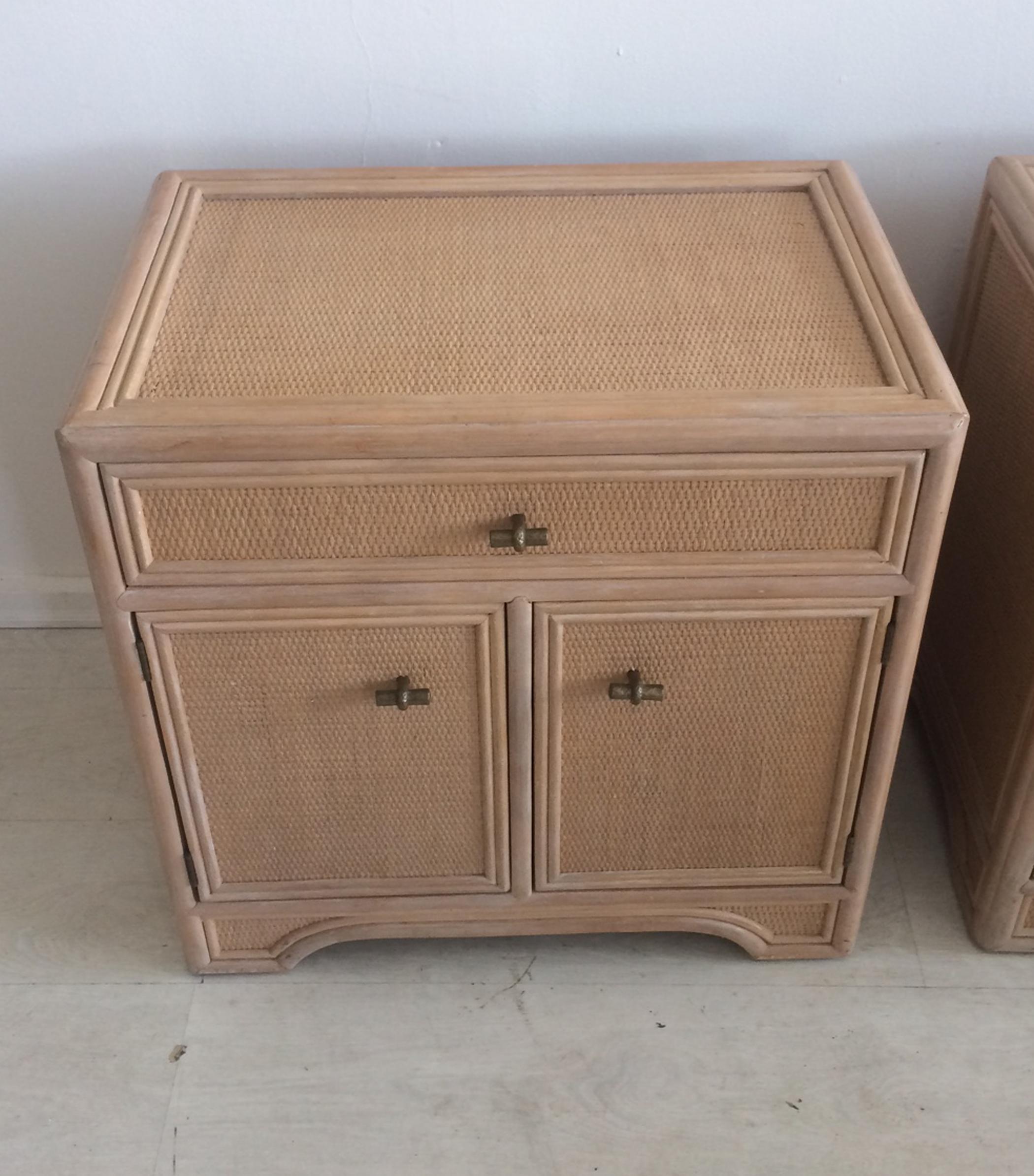 Chinese Chippendale style nightstands made by Ficks Reed. Constructed with rattan and woven cane. Upper drawer with double door cabinet below cast brass or bronze hardware. Quality furniture from a quality company. Works with many different decors
