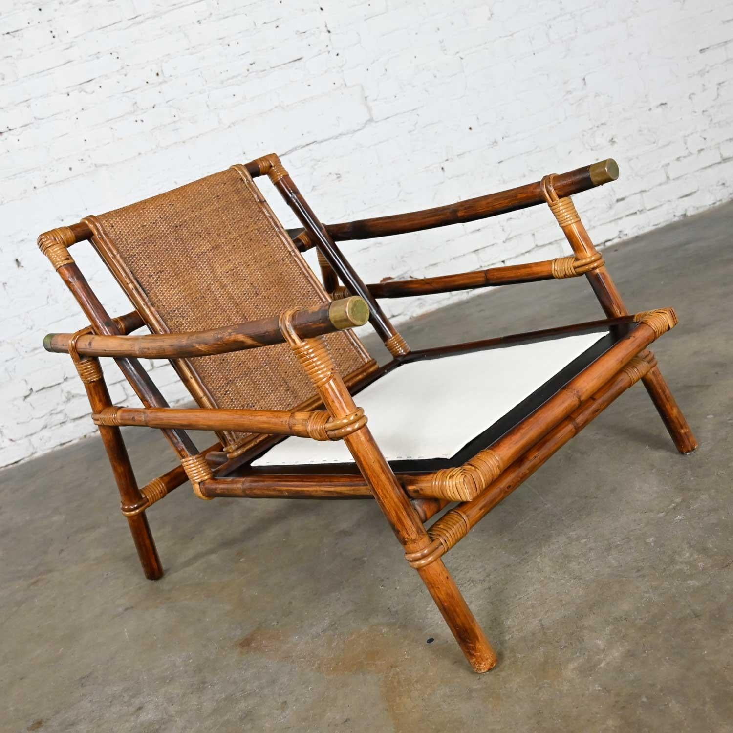 Wonderful vintage rattan Campaign Style Ficks Reed Far Horizons Collection lounge or club chair designed by John Wisner. Beautiful condition, keeping in mind that this is vintage and not new so will have signs of use and wear. It has been
