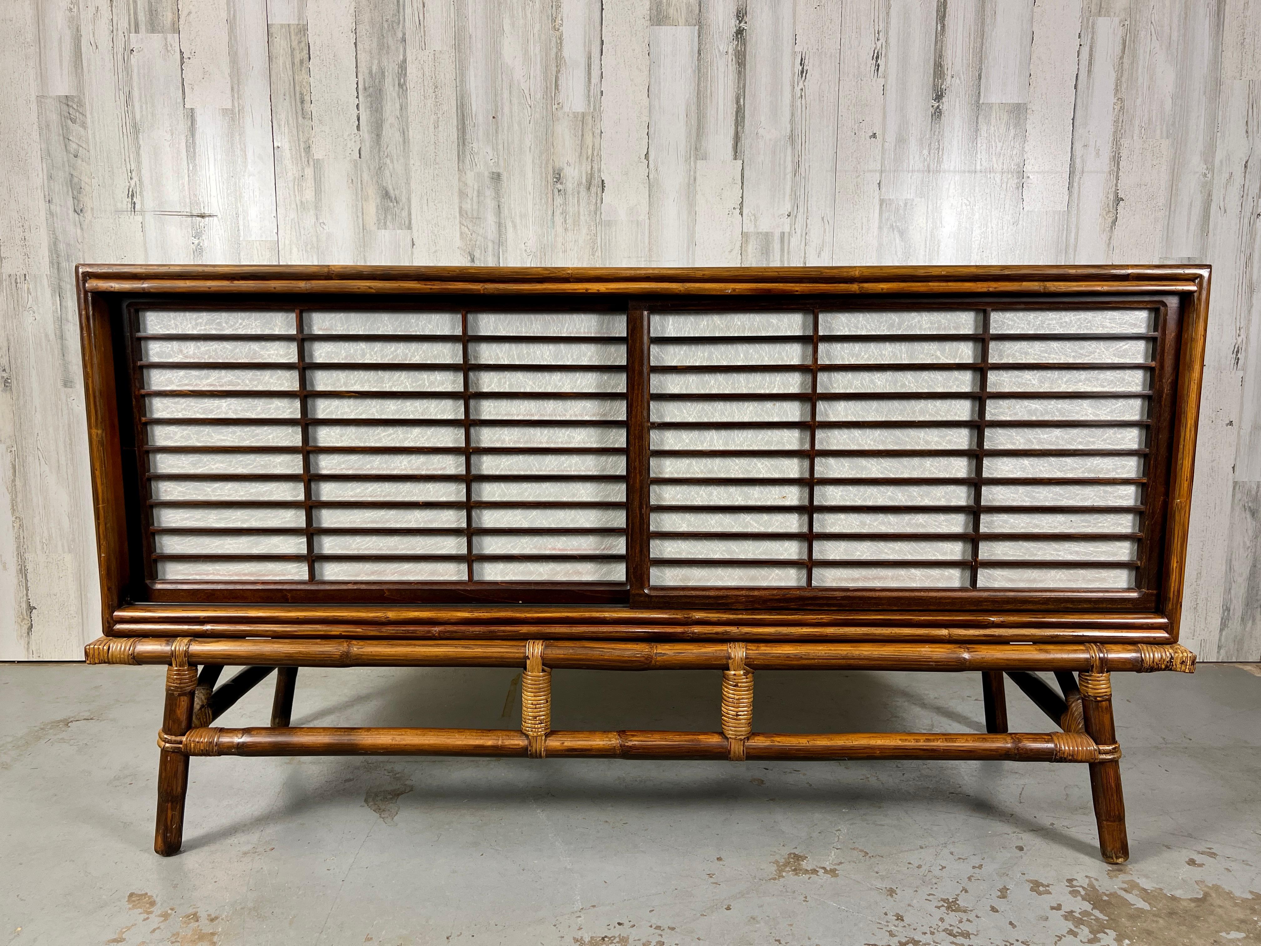 Ficks reed rattan & oak credenza with rice paper front sliding doors.