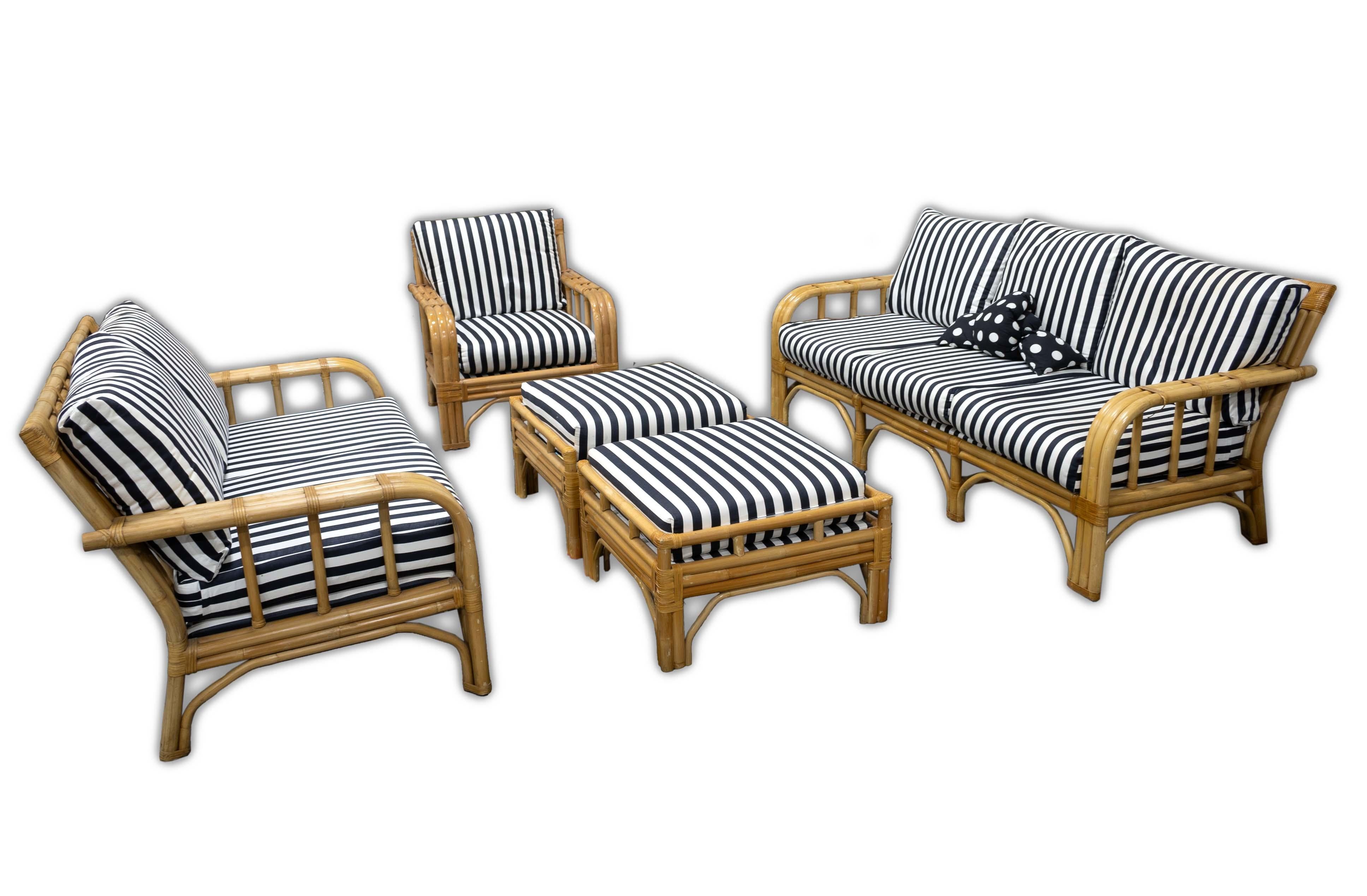 A Ficks Reed Rattan Black and White Stripped Set Sofa, Loveseat, Chair and Two Ottomans. The perfect set for an outdoor patio or a summer room of a Mid Century Modern lover. With its black and white cushioning, this piece can easily fit into any