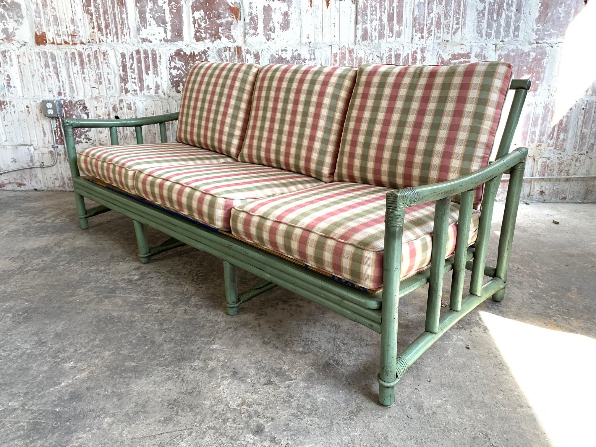 Midcentury rattan bamboo sofa by Ficks Reed features a 3-seat frame and a perfect amount of patina from age. Very good vintage condition.