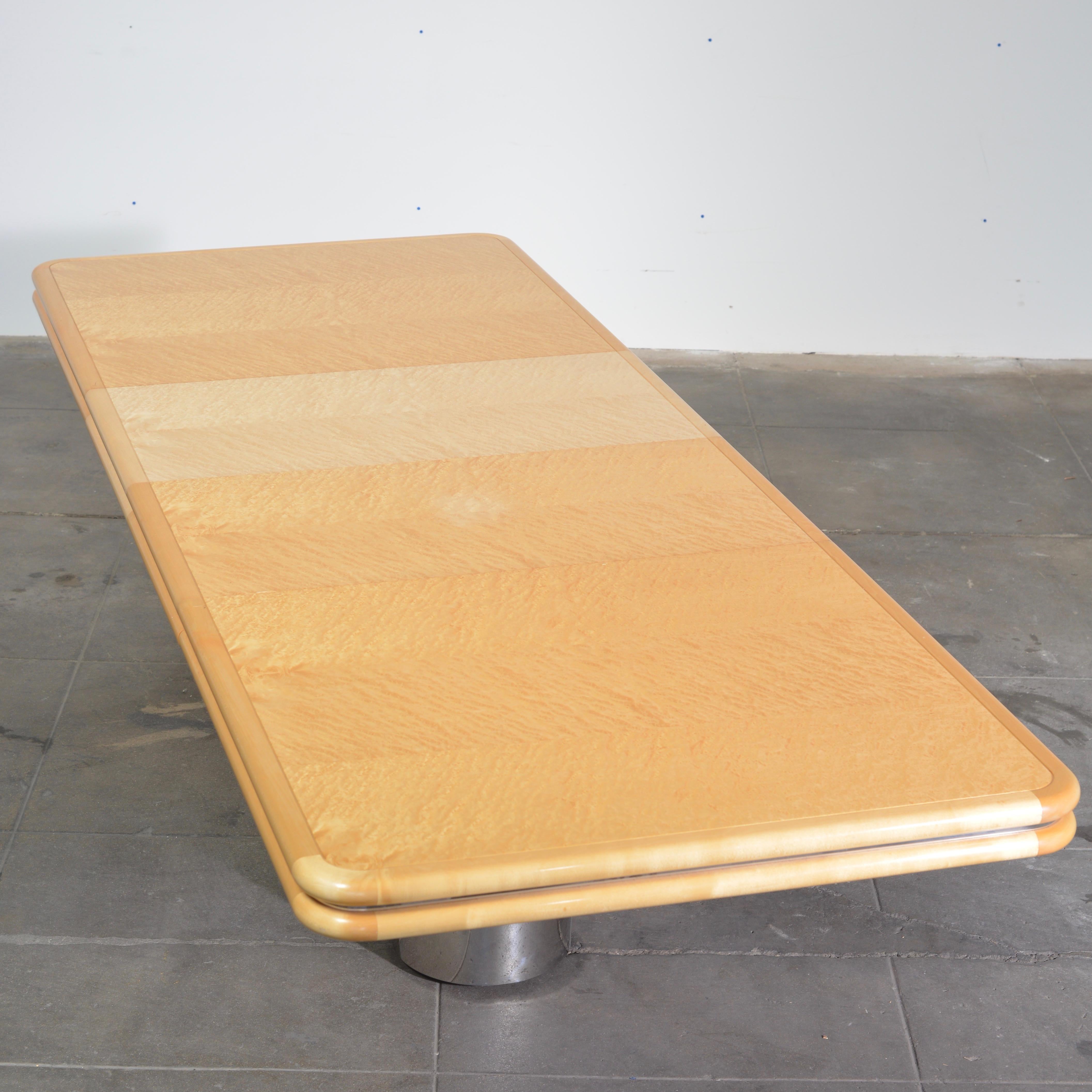 Monumental fiddleback maple dining table designed by Stanley Jay Friedman for Brueton with polished stainless steel 3-drum base and 3 large extensions. The table is great condition with almost no visible wear.