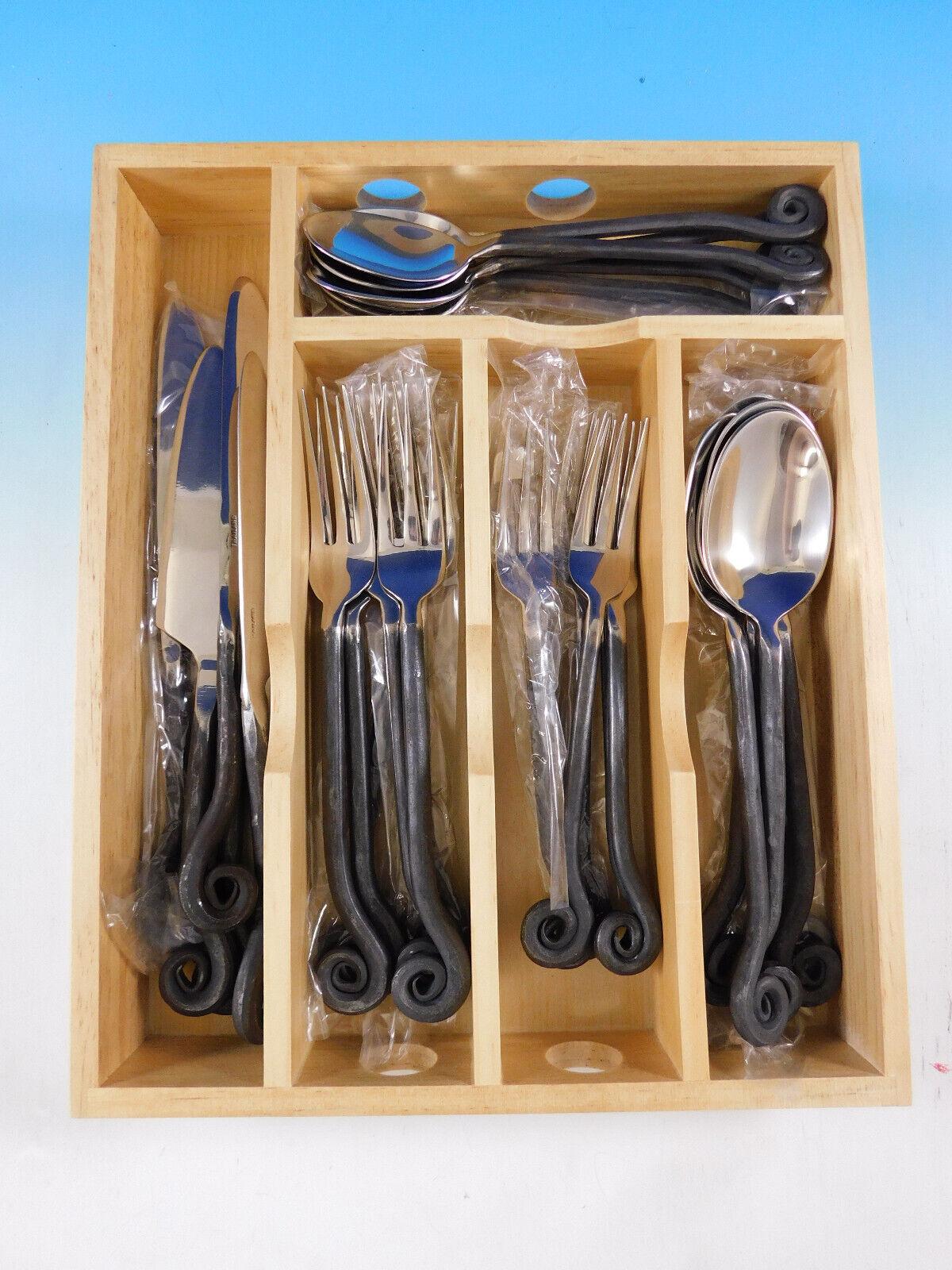 Fiddlehead by Pottery Barn oxidized stainless steel Flatware set, 30 pieces. 
A very similar cutlery is featured in Harry Potter Chamber of Secrets in Hogwort's Great Dining Hall! (See 5th & 6th photo in this listing of still photos from the