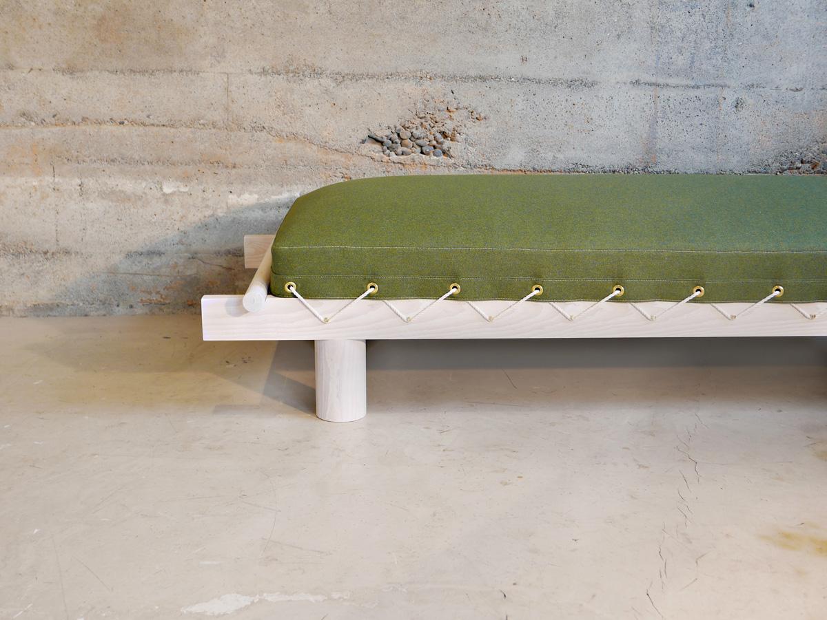 The Field bed by Hinterland Design is a modern take on the army cot. Made of solid Canadian white ash, the 7-foot long frame is then whitewashed and topped with an overstuffed wool upholstered cushion. This day bed's down topped cushion is then