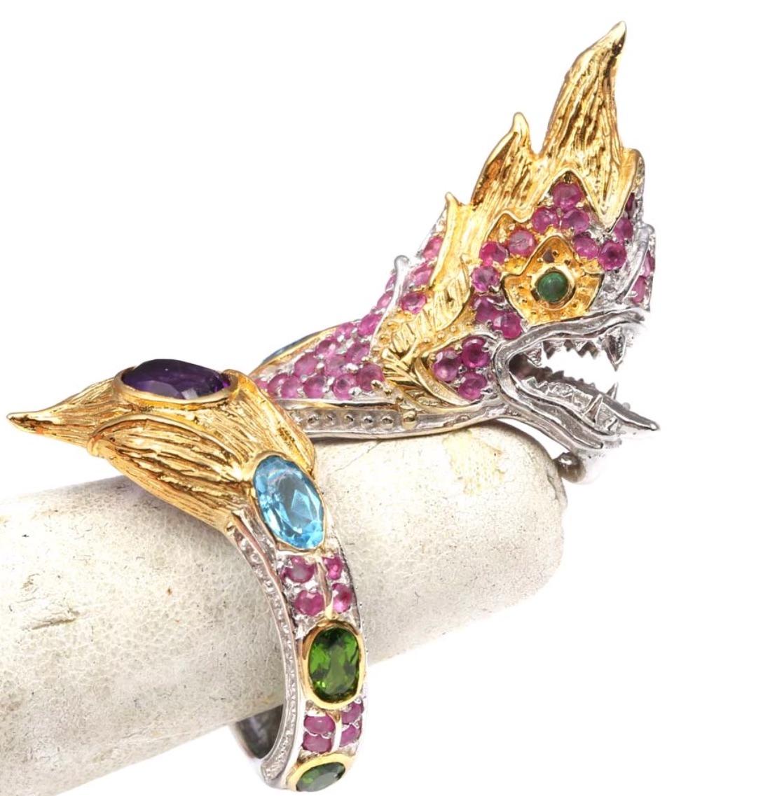 Be the One and Only to wear this Gorgeous Fierce Dragon wrapped around your finger-any finger that fits is fitting!
A colorful rainbow of gems cover this dragon with his mouth open, teeth showing and tongue out daring anyone to play his