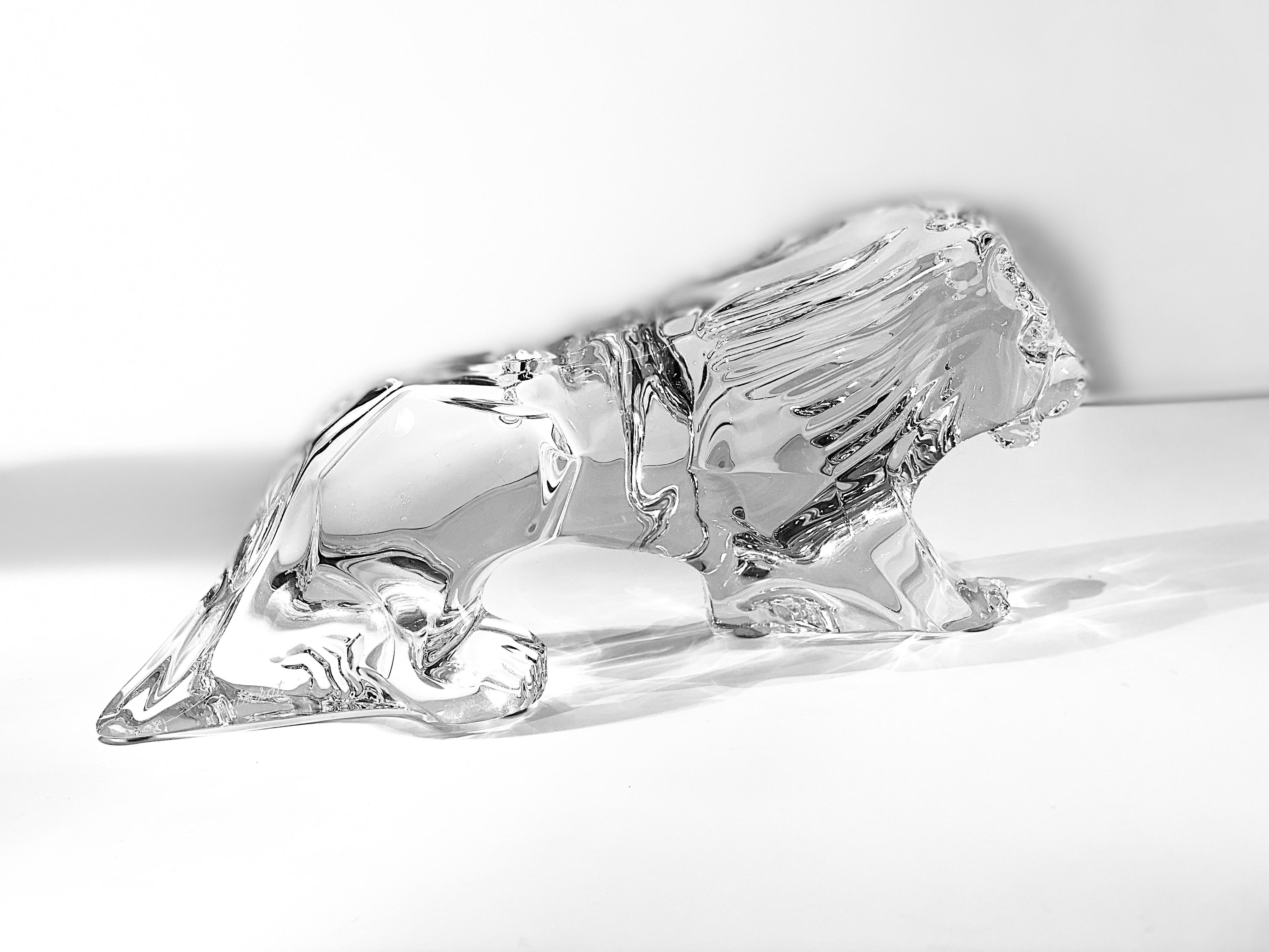 Beautifully handmade and hand blown in France, Baccarat crystal walking lion animal figurine. Stately and fierce as could be, the Baccarat walking lion will make a wonderful addition to any home or office. Etched signed with the Baccarat name on the