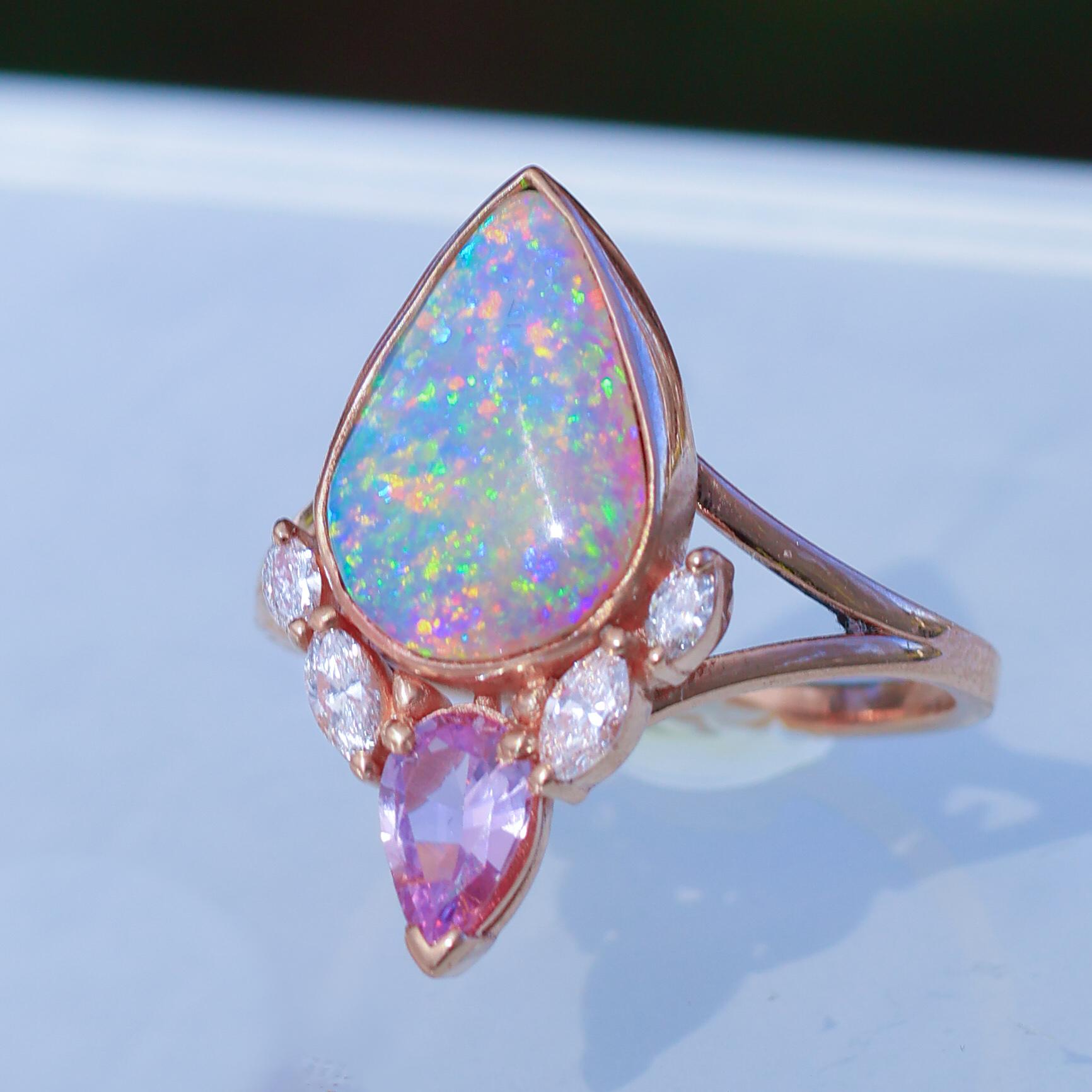 Amazing Fiery Australian Opal Lotus Bud Ring, Fuchsia Sapphire, Diamonds, Solid 14k Rose Gold. 22mm in length.

 
This is a very special opal! Quite a significant size for such amazing unique coloration and fire and colorful bright fire! A blue and