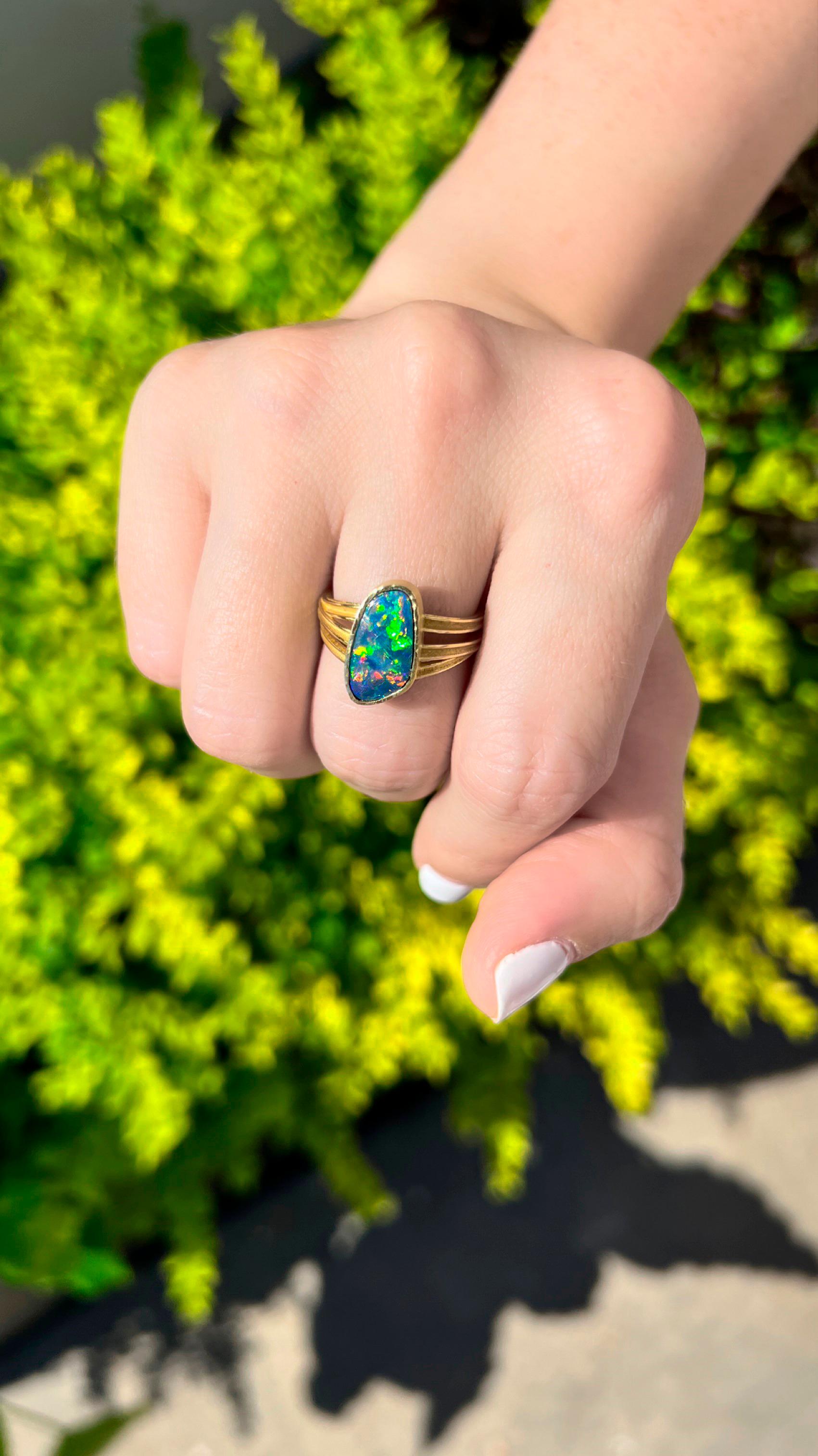 One of a Kind Ring handmade by award-winning jewelry designer Barbara Heinrich featuring a phenomenal, electrifying 2.31 carat gem boulder opal with extraordinary rainbow flash, bezel-set in hand-hammered 18k yellow gold atop Barbara's signature 18k