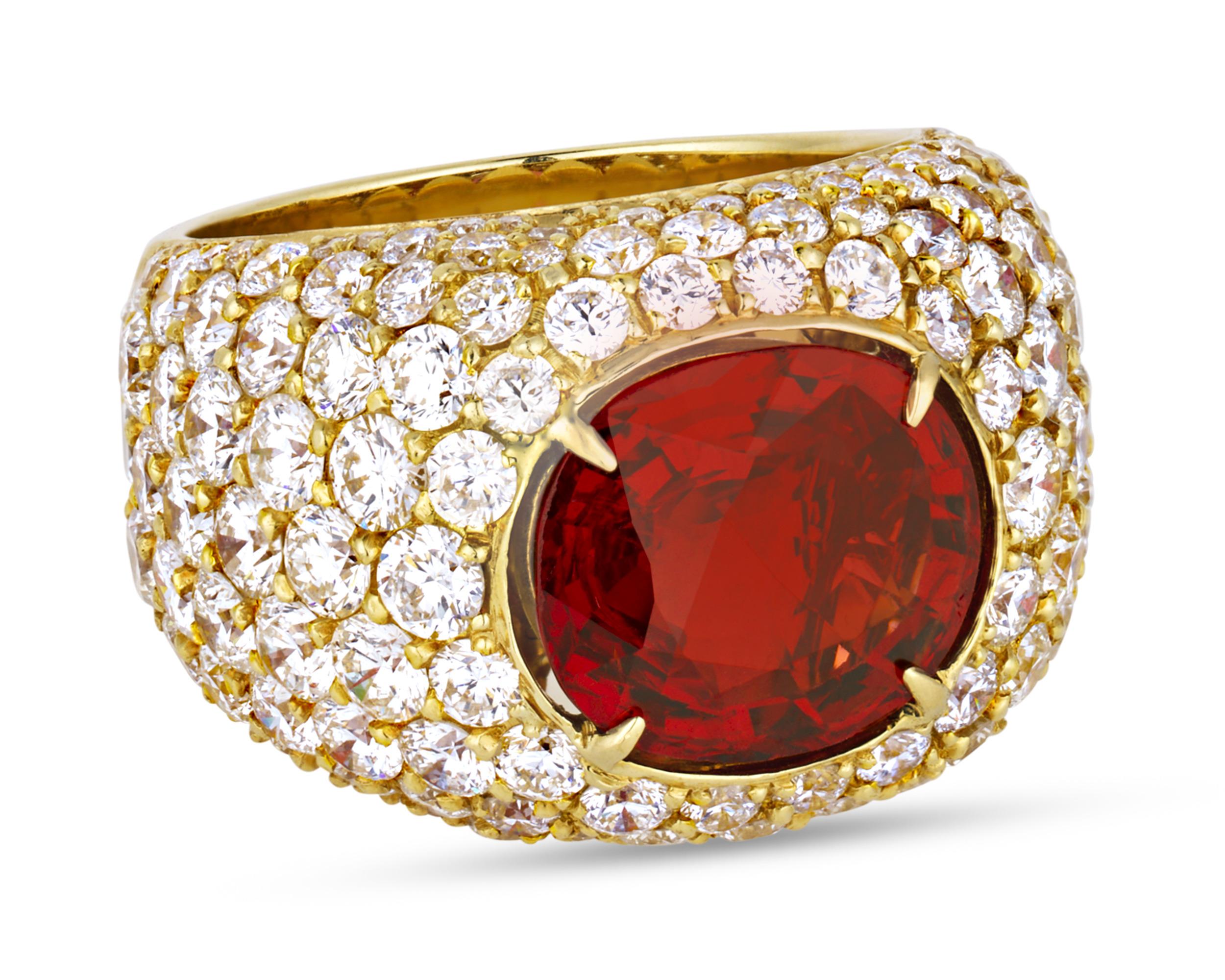 A fiery spinel weighing approximately 5.00 carats takes center stage in this stylish ring. Exhibiting a dramatic deep orange hue, this jewel is bezel set into a domed 18K yellow gold setting encrusted in brilliant white diamond accents.