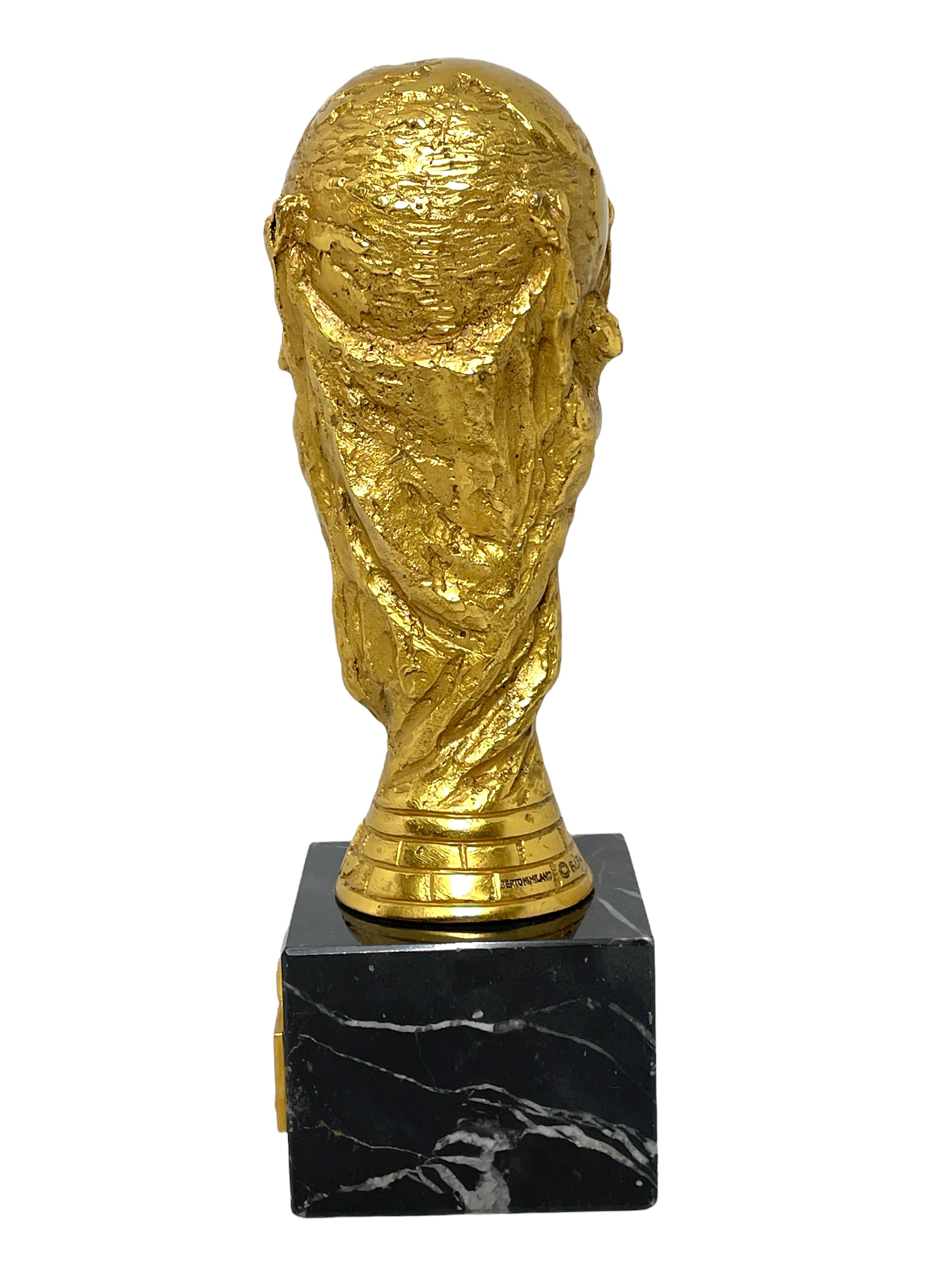 A beautiful substantial and stunning trophy made by Bertoni Milan Italy. This trophy was a give away, awarded to players, staff, coaches and federation members. It is a miniature, heavily build out of Bronze with a black marble base and is signed.