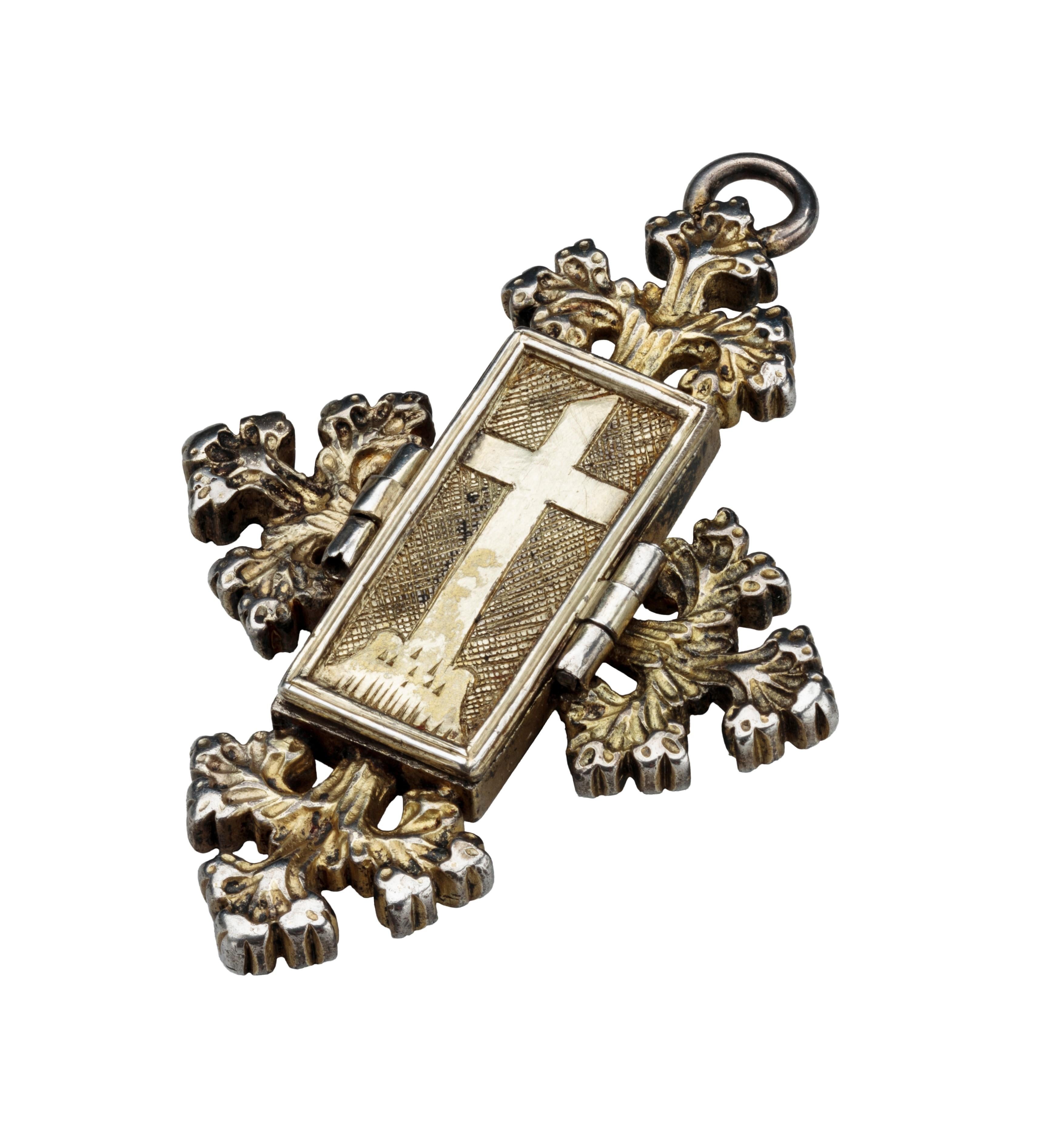 Reliquary Pendant with Christ on the Cross
Germany, c. 1480–1500
Gilded silver
Weight 35 grams; dimensions 69 × 46 × 8 mm

A mixture of forms gives this pendant a rare expressiveness. At its core is a hinged rectangular box that likely once