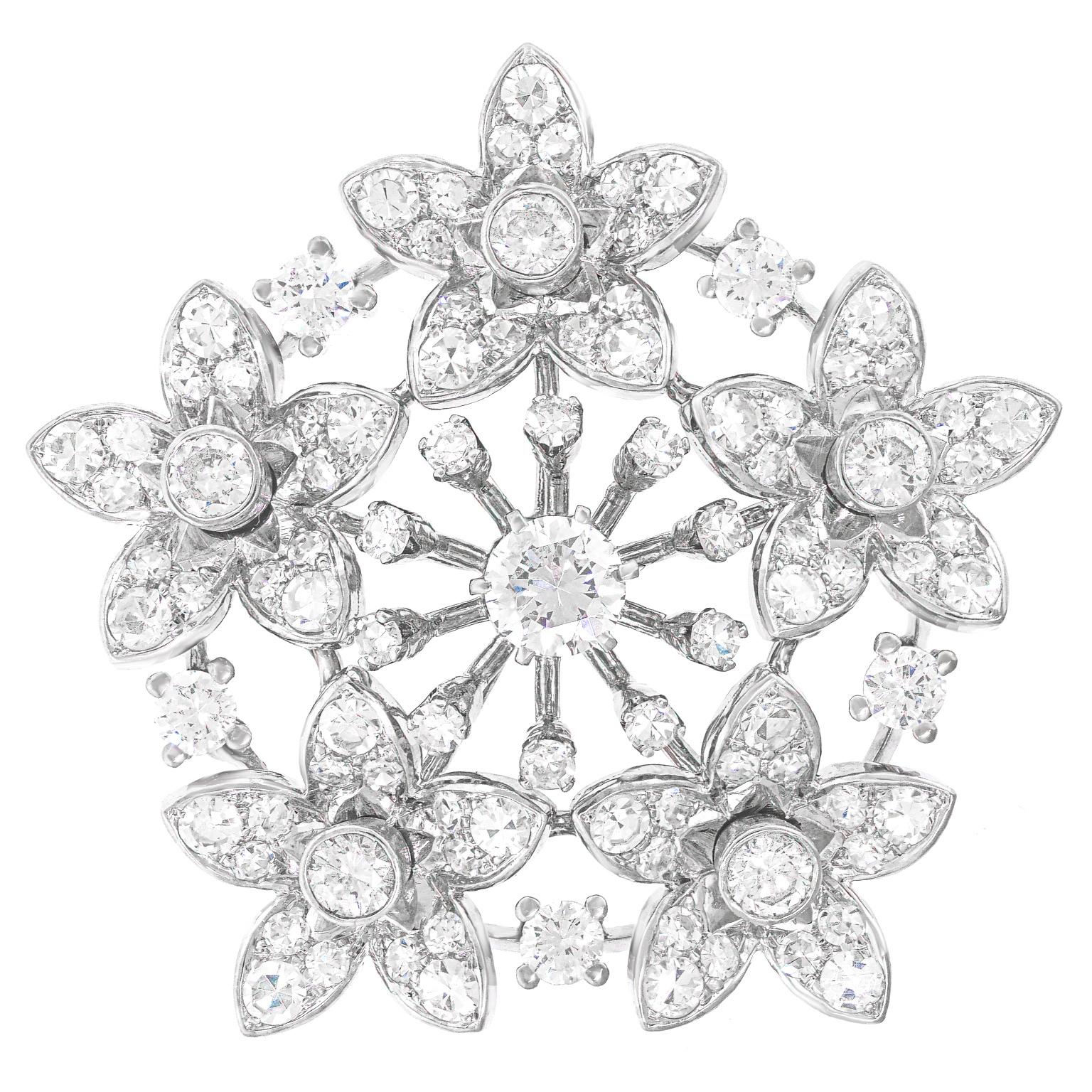 Circa 1940-50s, 18k, Lisbon.  This chic diamond-set brooch is an explosion of stars, flowers, or snowflakes… take your pick. Set with four carats of superior quality diamonds ( F to G color and VS clarity), the look is underscored with superb