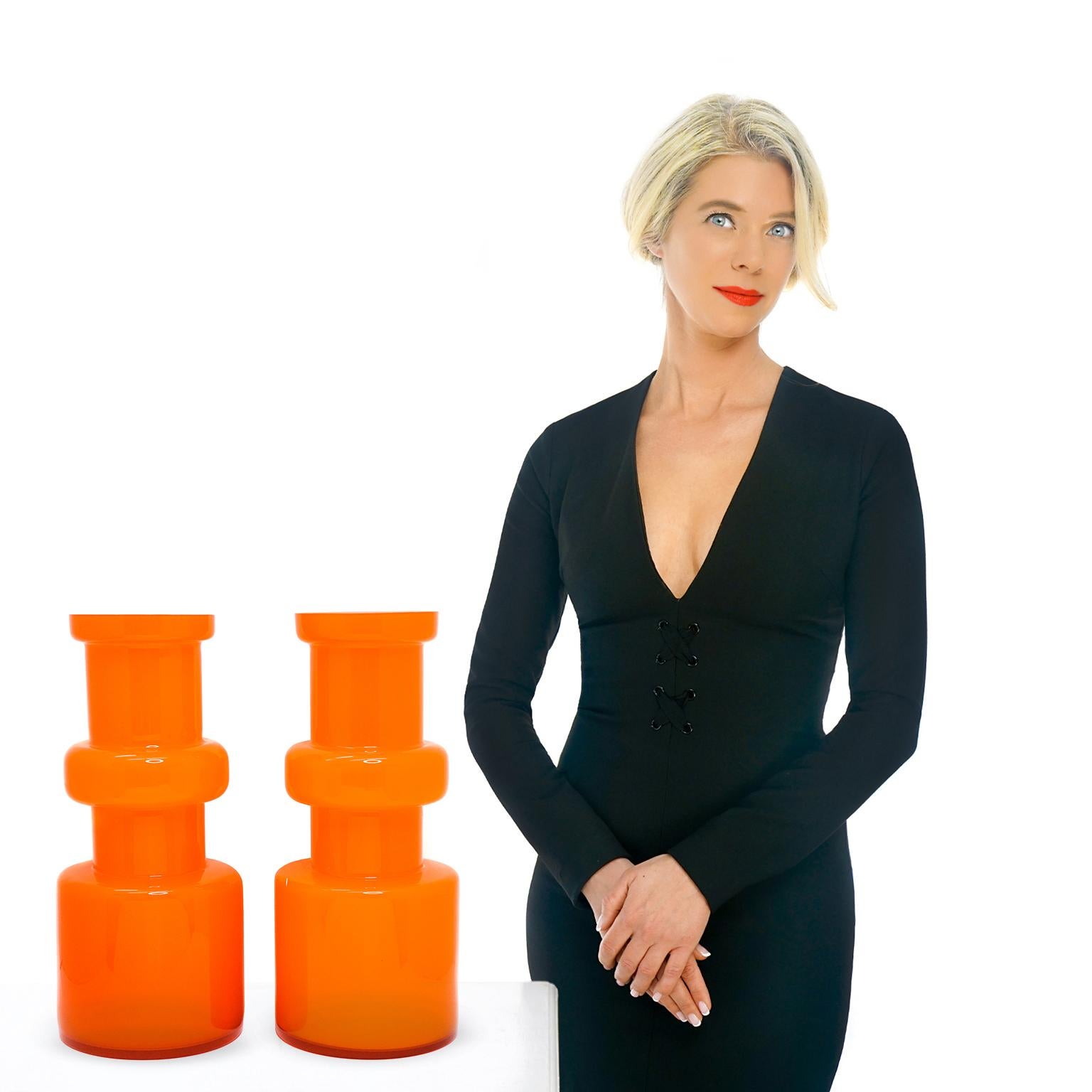 Circa 1950s, Italy.  This hyper modern pair of vases are the epitome of Italian design fifties style. The color is utterly fabulous and very unusual, a particularly bold orange. Beautifully made cased glass, they are white on the inside. Excellent