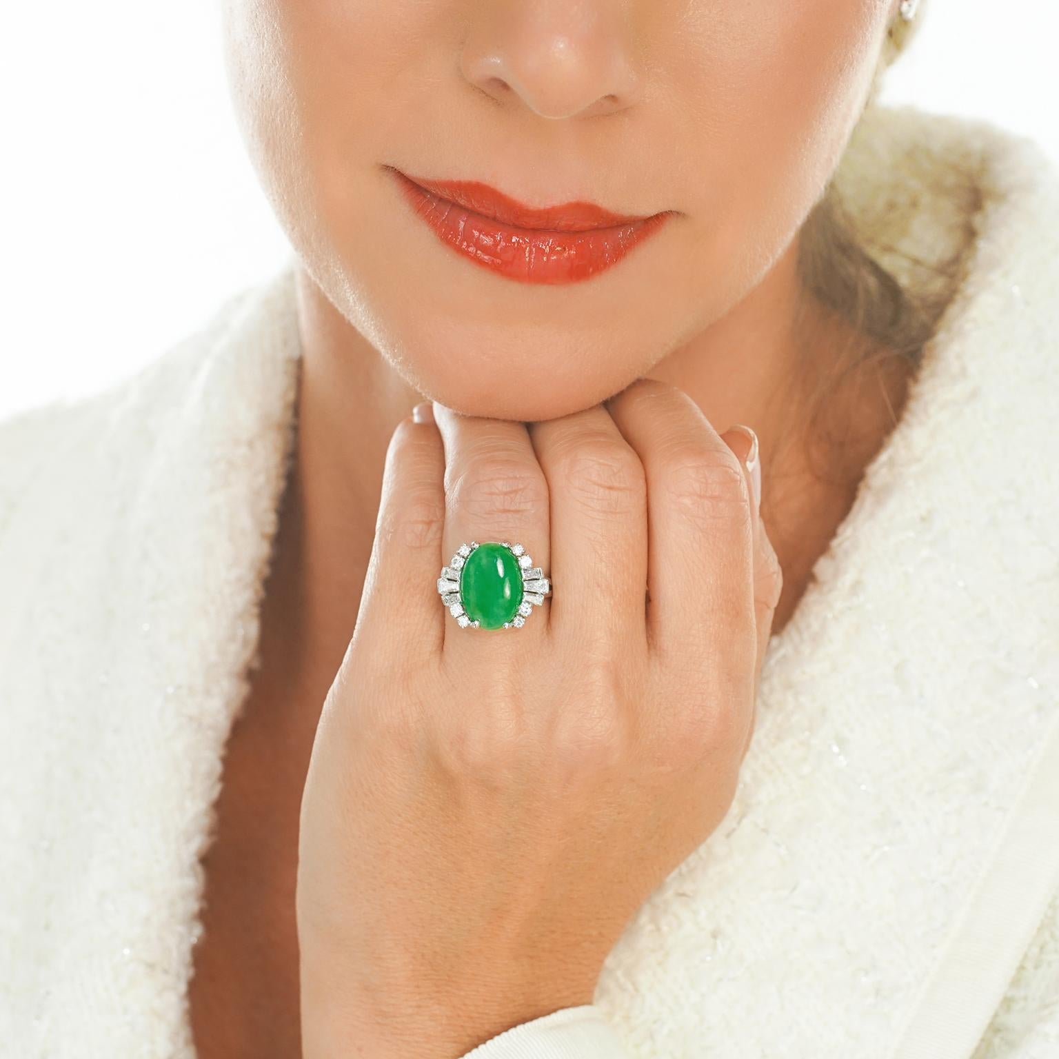 Circa 1950s, Platinum, by F&F Felger, Newark, NJ, American. This sublime fifties platinum ring features brilliant white diamonds (G color VS clarity) surrounding a superb natural green jade cabochon. Using only the finest materials available, this