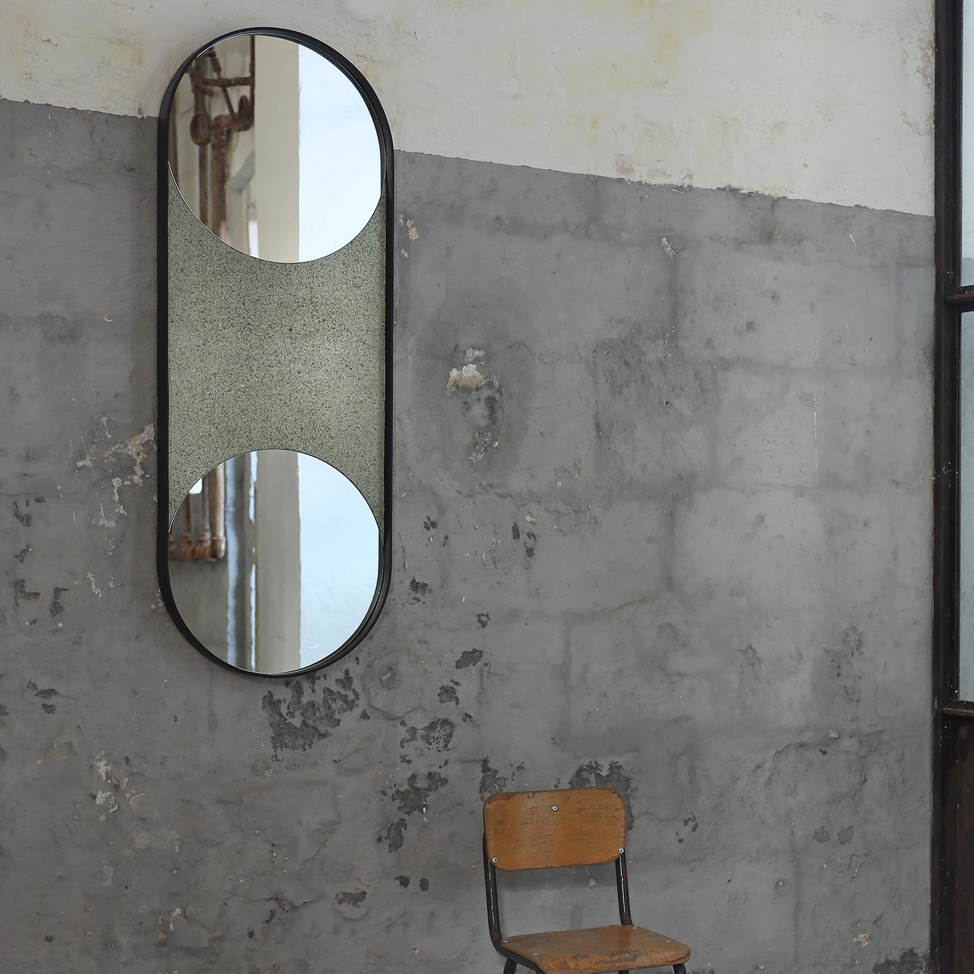 Spot-on addition to contemporary decors committed to sustainability values, this oblong mirror with rounded extremities offers two distinct, round mirrored glass surfaces encased within a frame in poplar blockboard that lacquered by hand in black
