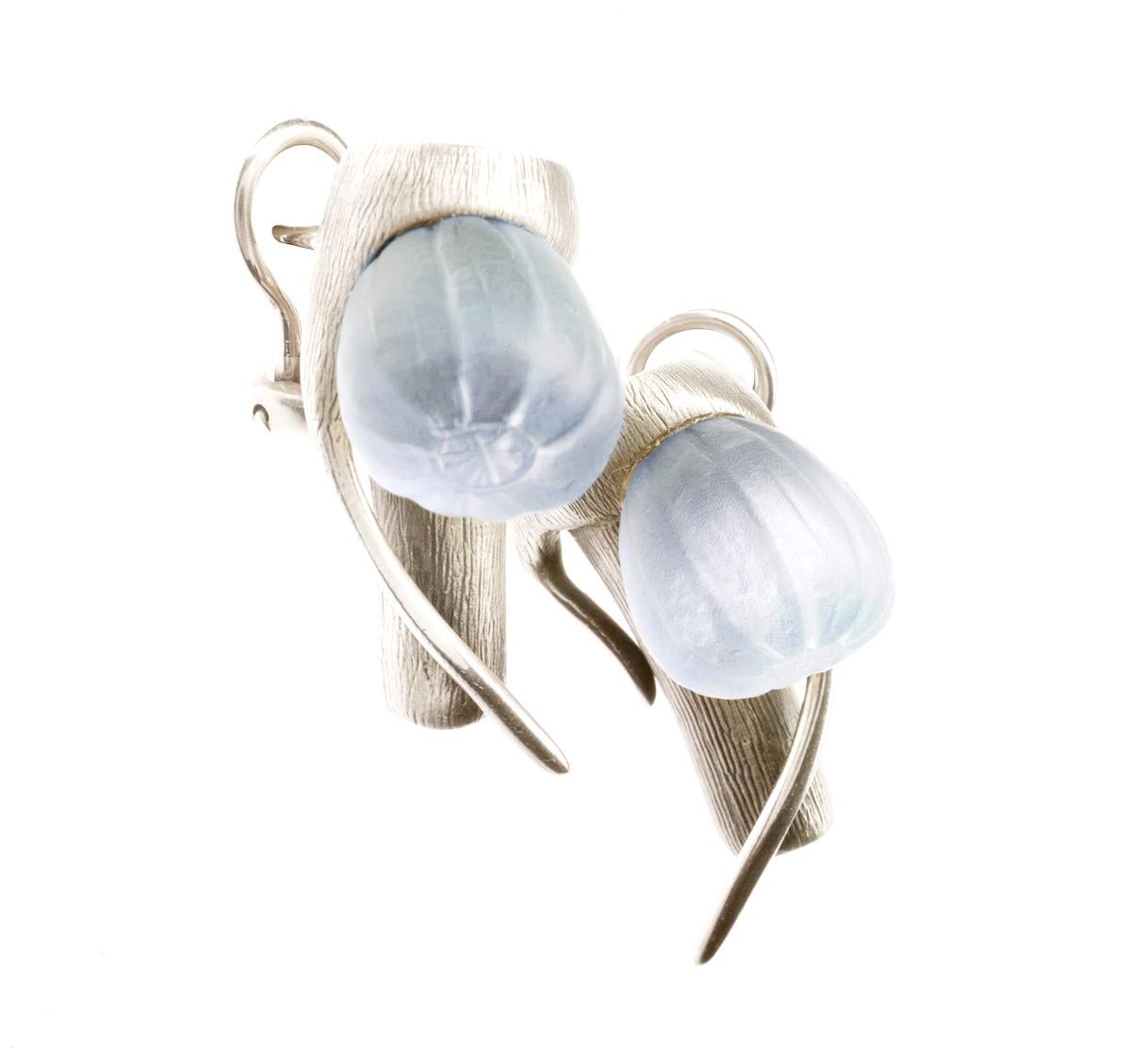 These fig earrings are three-dimensional, made of sterling silver and adorned with frosted blue quartzes. They complement sun-kissed skin and enhance the face with delicate color flashes. This designer jewelry piece is handcrafted and belongs to a