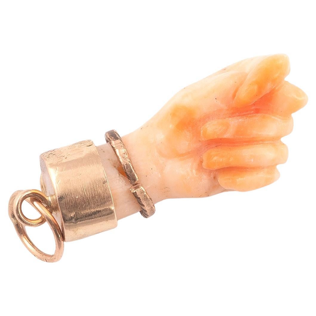 A beautiful figa hand charm made of *coral and set with a 14 karat gold bail. The hand is nicely detailed. The charm is great worn alone or layered with your other favorites. The charm comes without the necklace. 
The figa hand symbol dates back